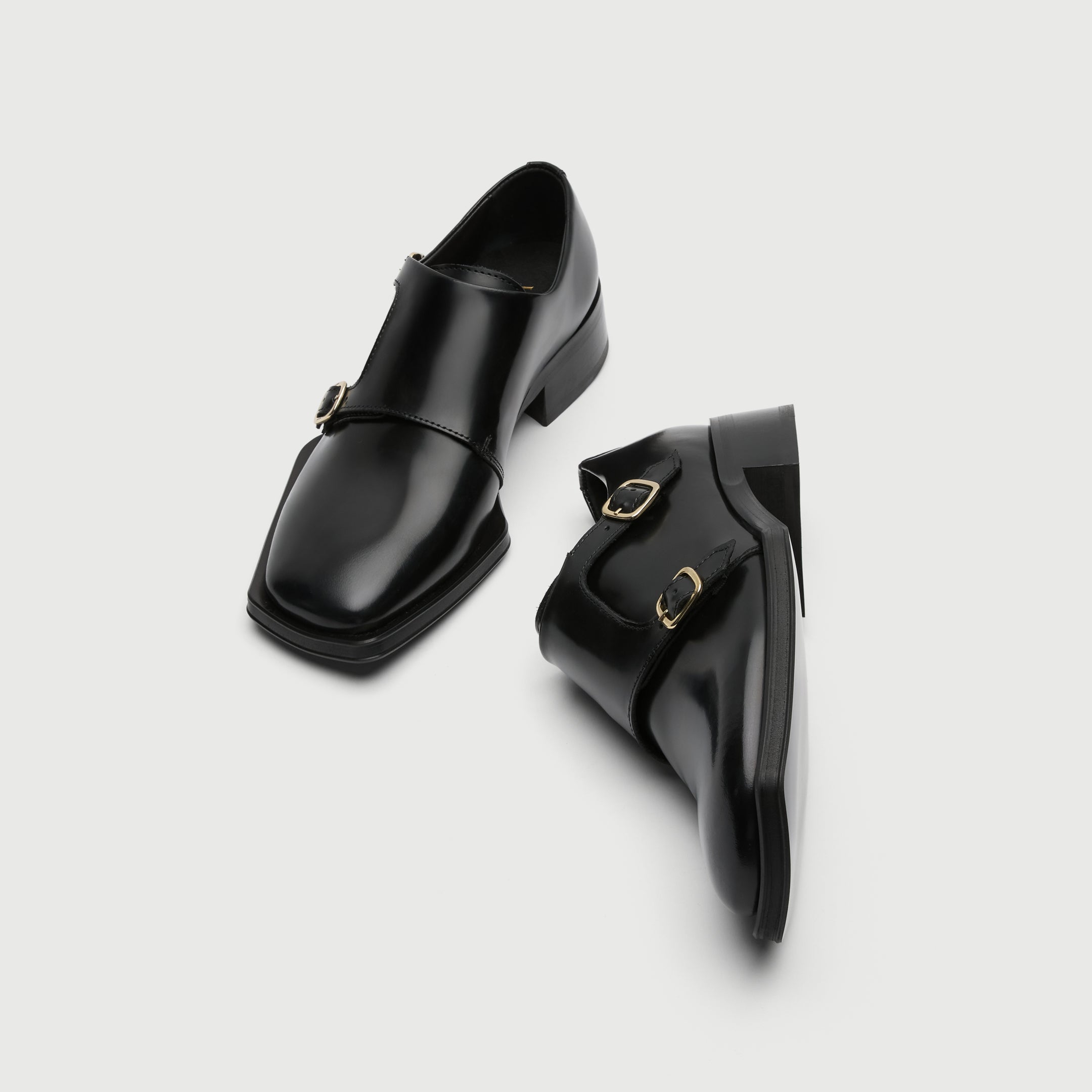 Black leather shoe with a buckle on a light grey background - Walk London Abbey Monk Shoe top View