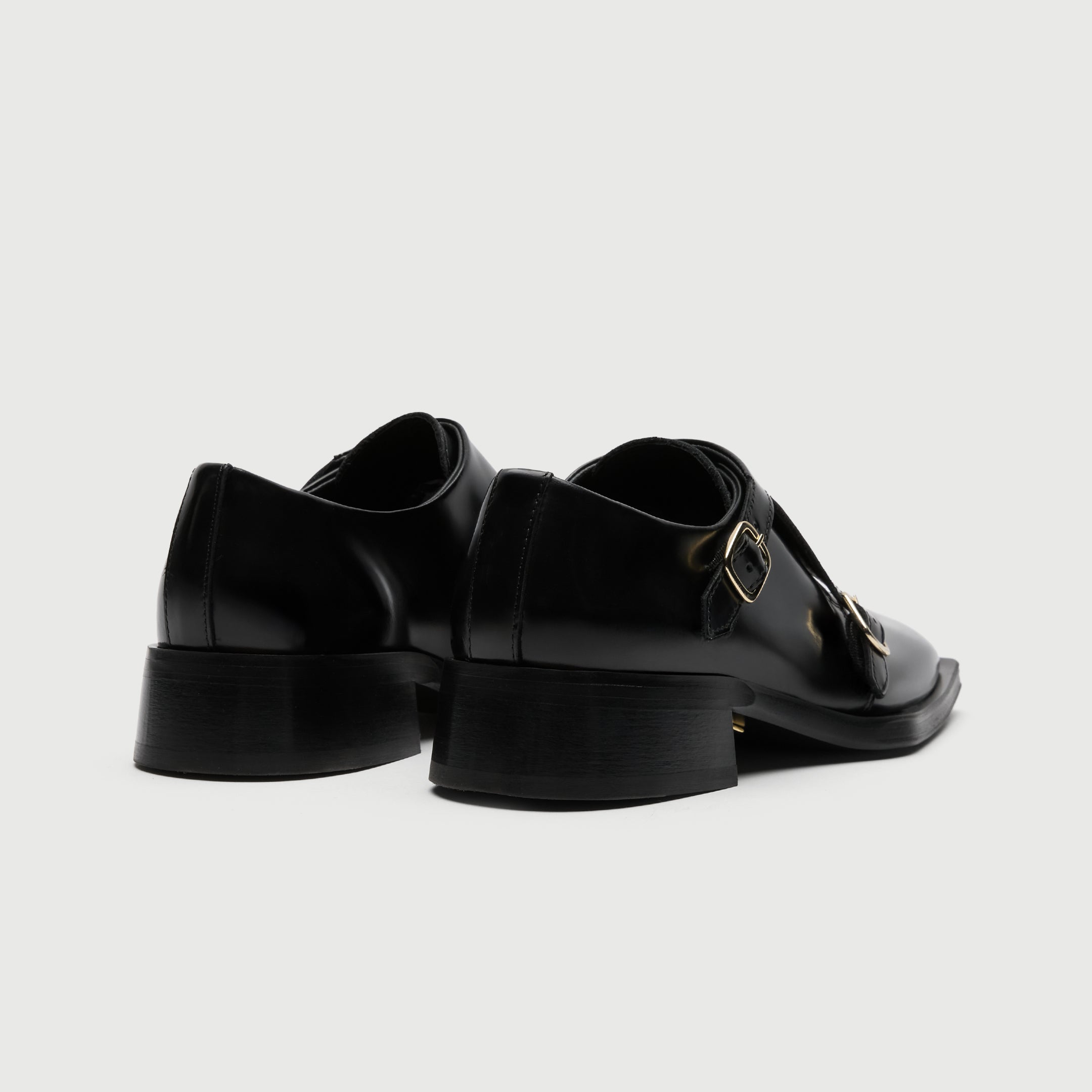 Black leather shoe with a buckle on a light grey background - Walk London Abbey Monk Shoe Back View of shoes