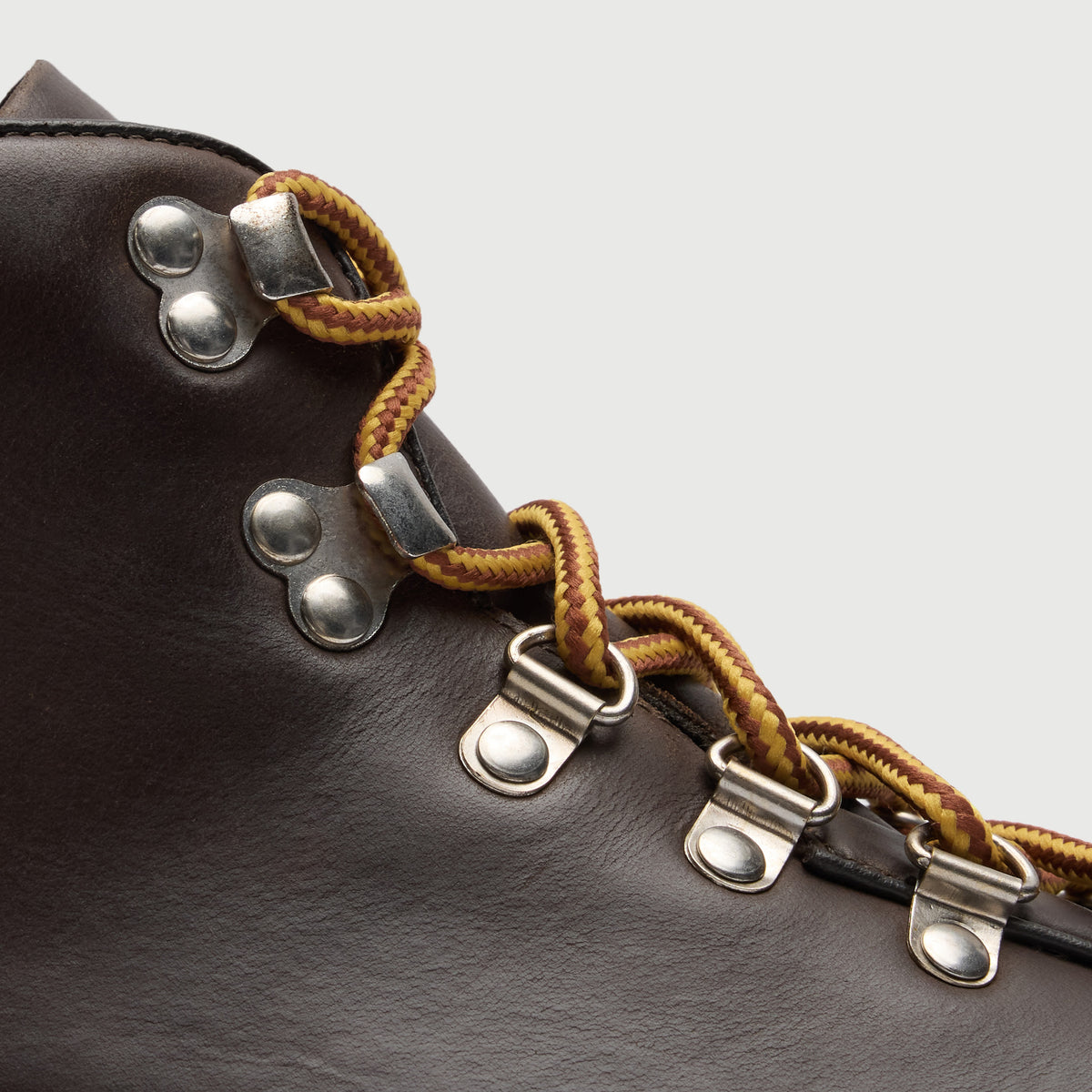 Walk London Blackheath Hiking Boot in brown leather close up showing yellow / brown lace, hooks and d-rings.
