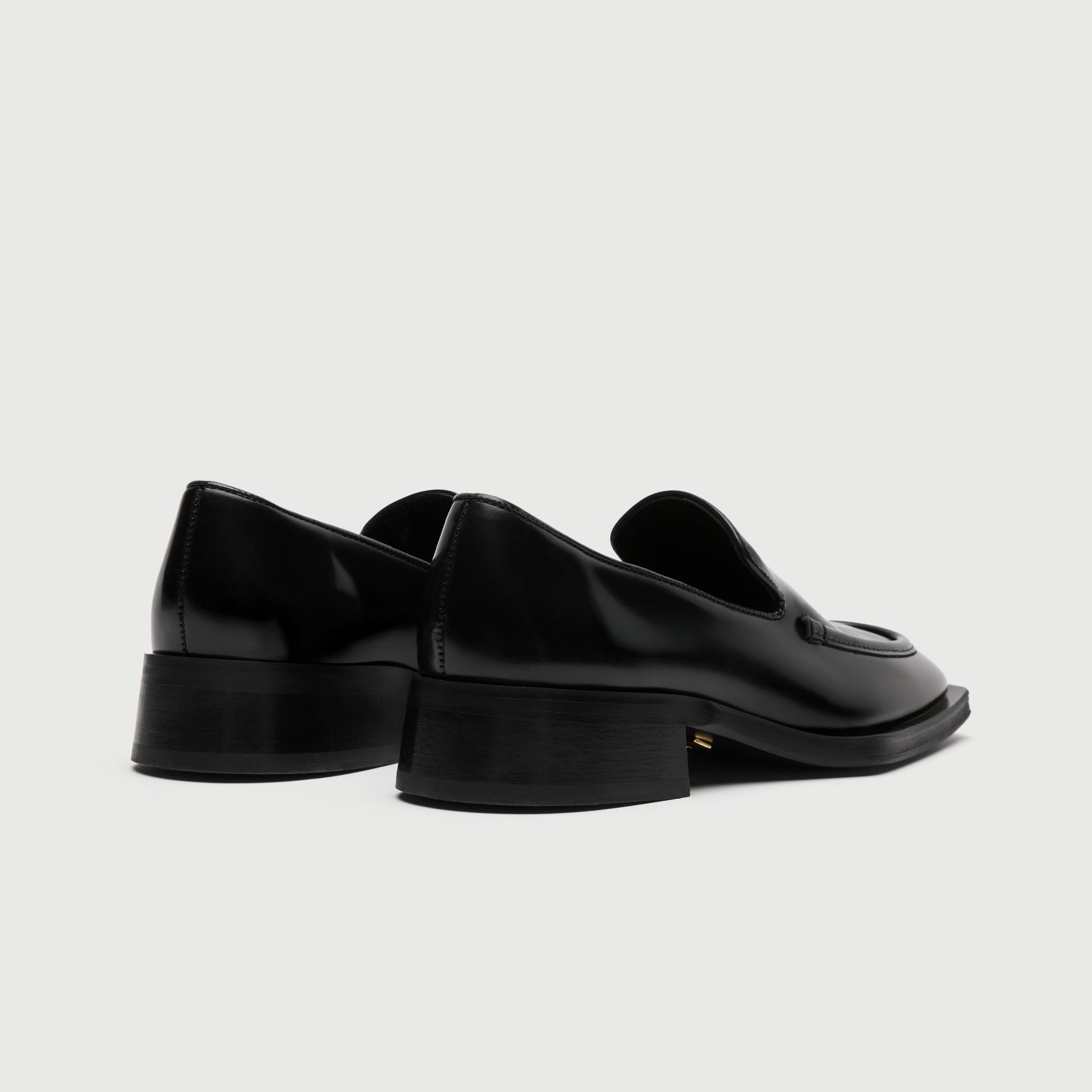 Black leather loafer with a light grey background - Walk London Abbey Loafer Back View