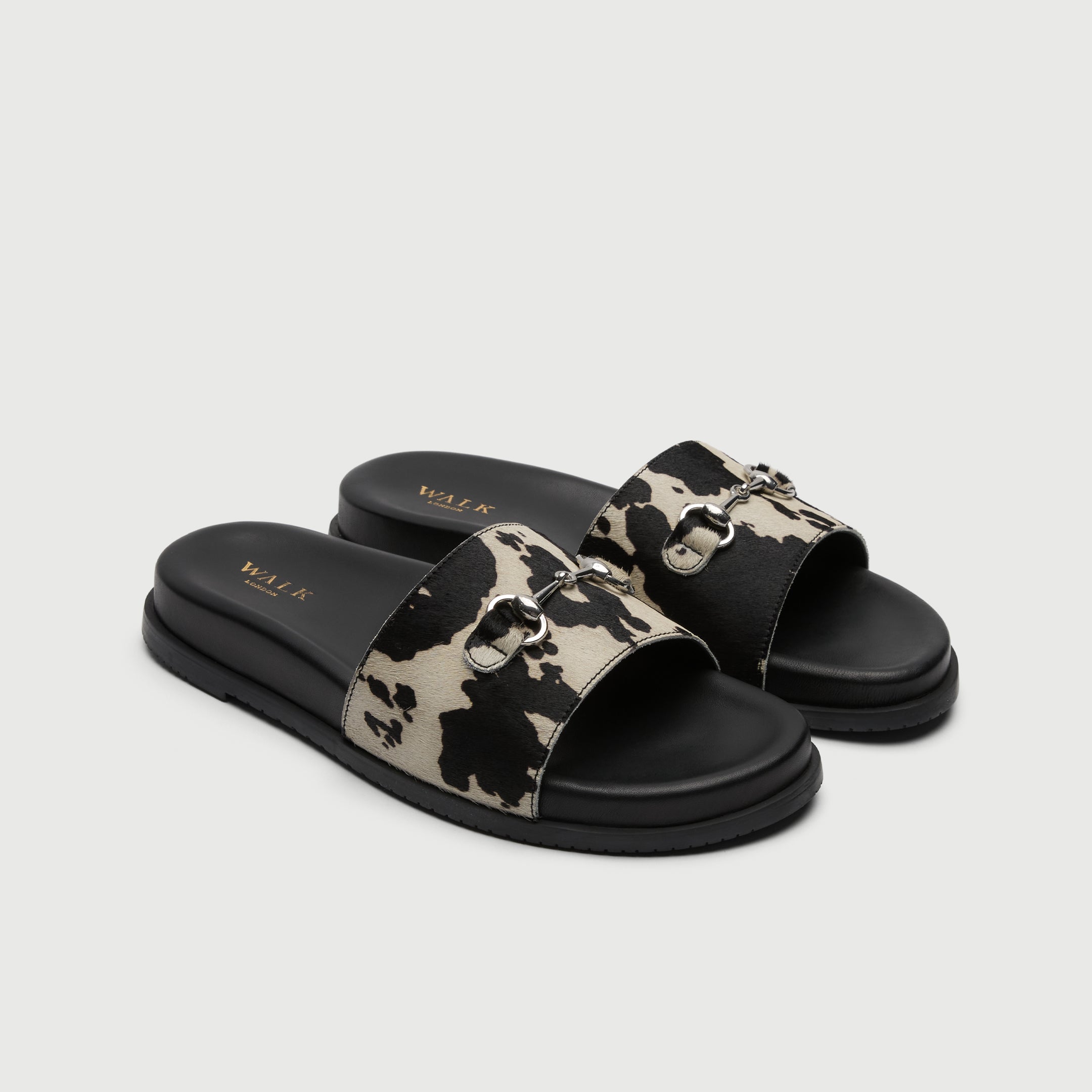 Walk London Breeze Trim Men's Leather Slider Sandal in cow print three quarter view