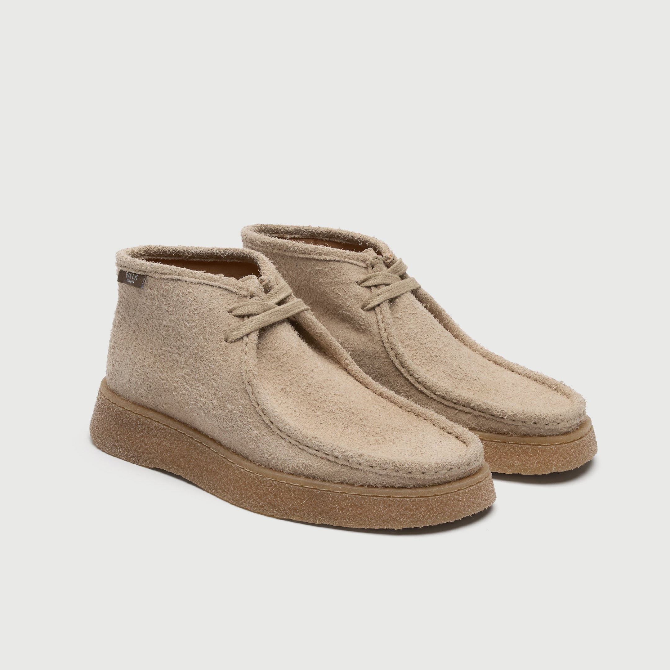 Beige suede shoe on a light grey background. Walk London Carnaby chukka boot side image pair