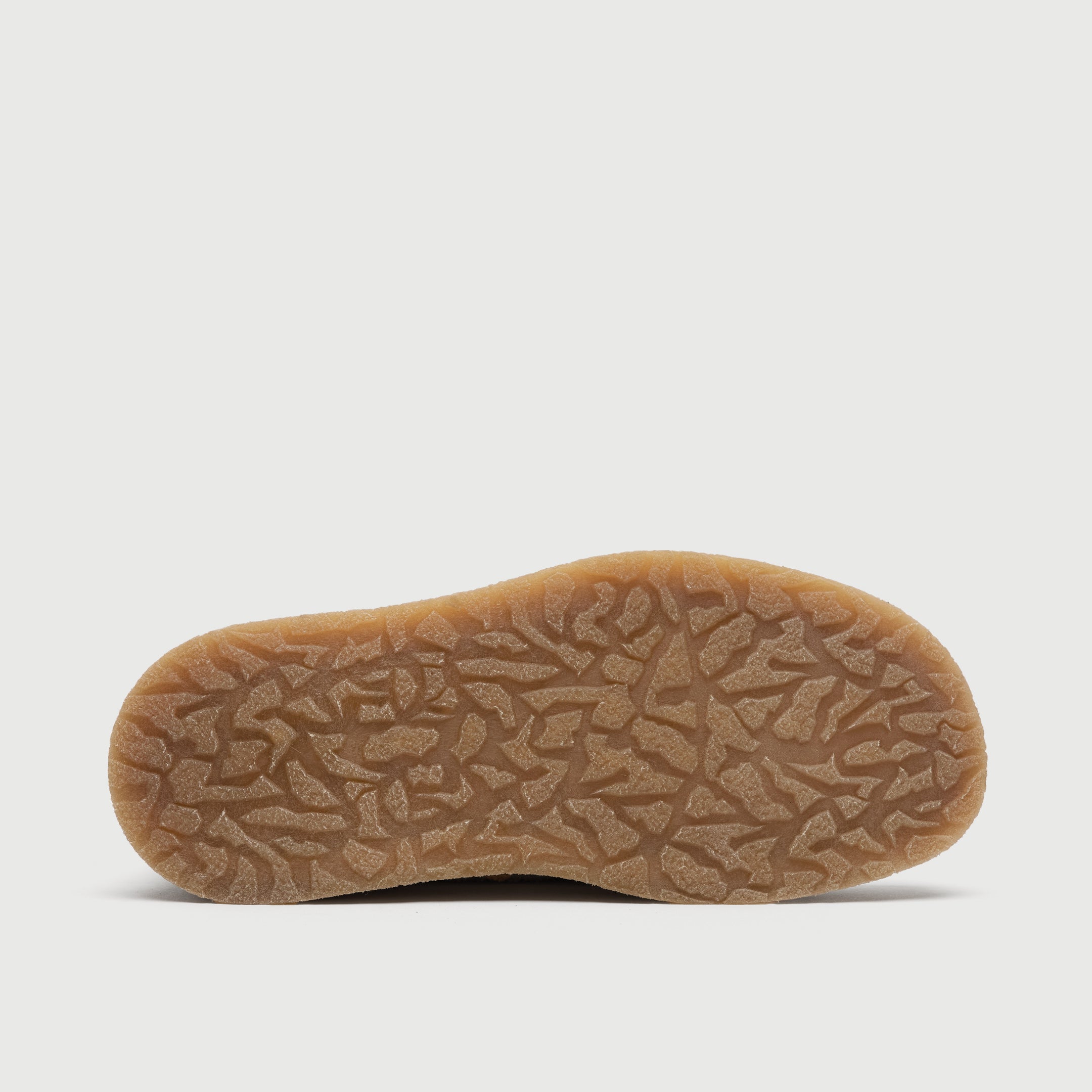 Beige suede shoe on a light grey background. Walk London Carnaby chukka boot sole image