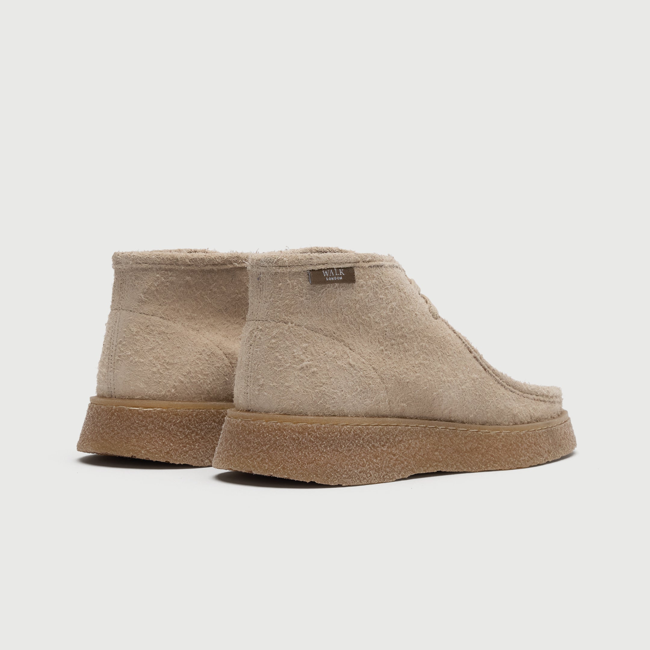 Beige suede shoe on a light grey background. Walk London Carnaby chukka boot back image