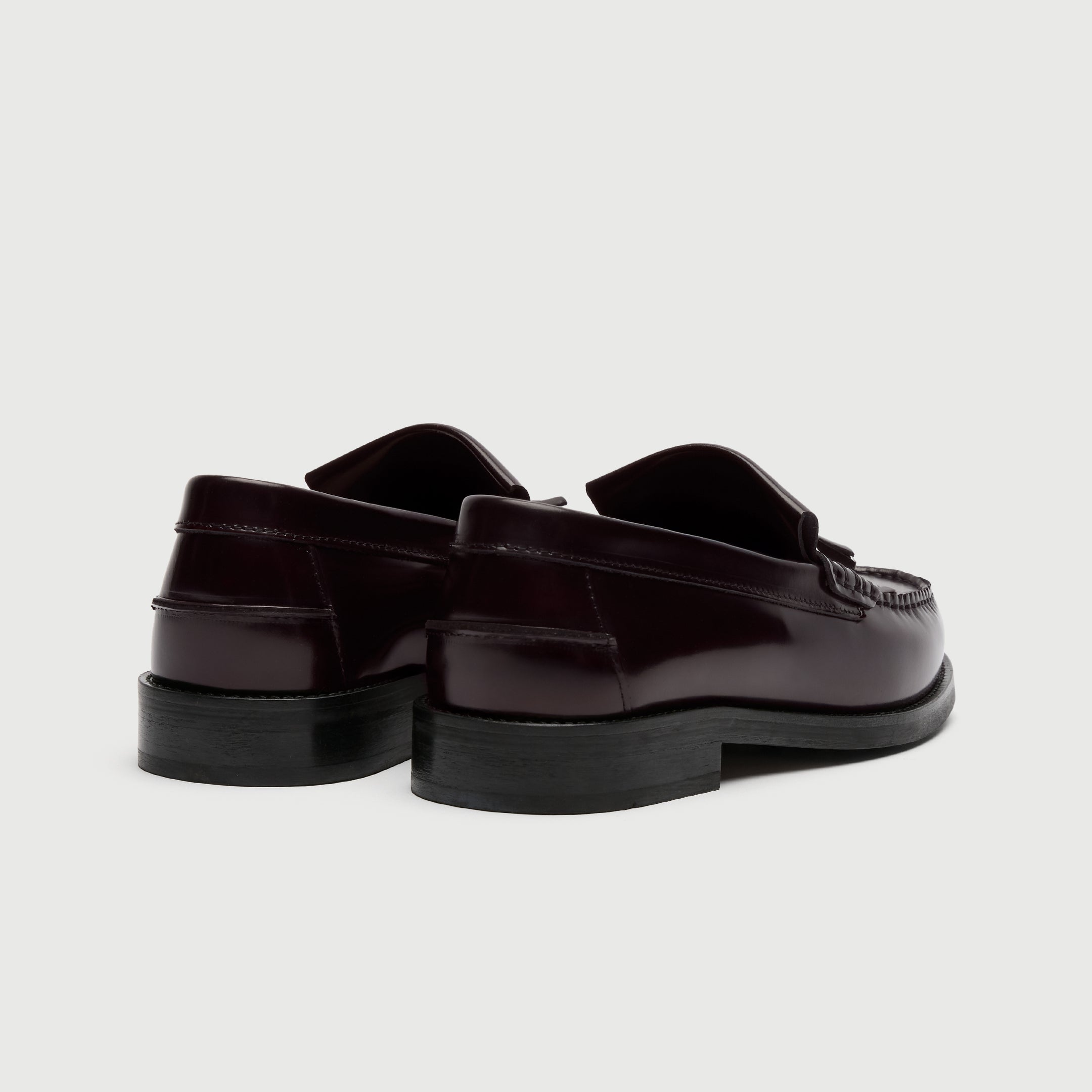 Pair of dark brown loafers on a light gray background - Walk London Dalston Fringe Tassel Loafer Burgundy Back