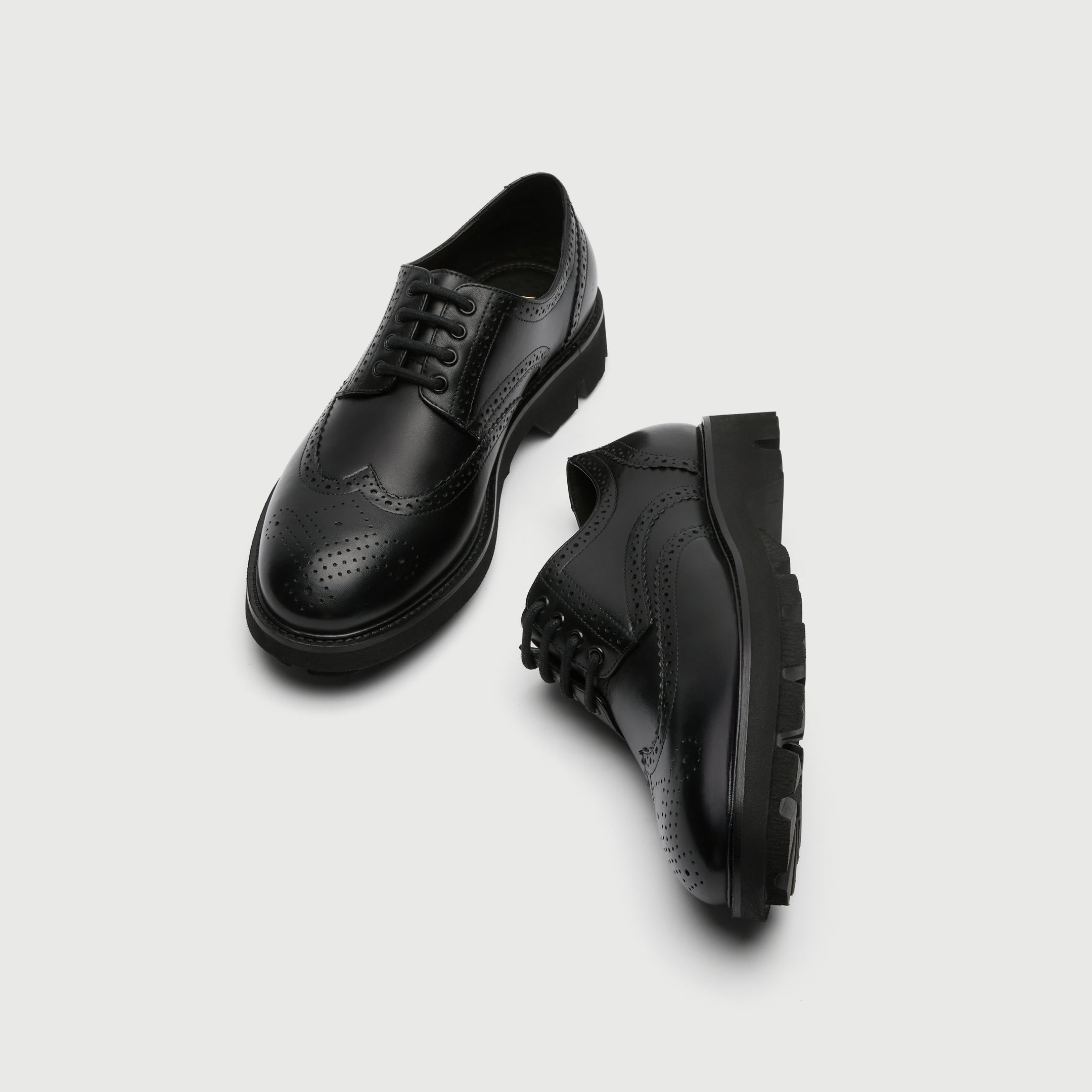 Black leather Walk London Felix brogue shoe on a light grey background. Top View