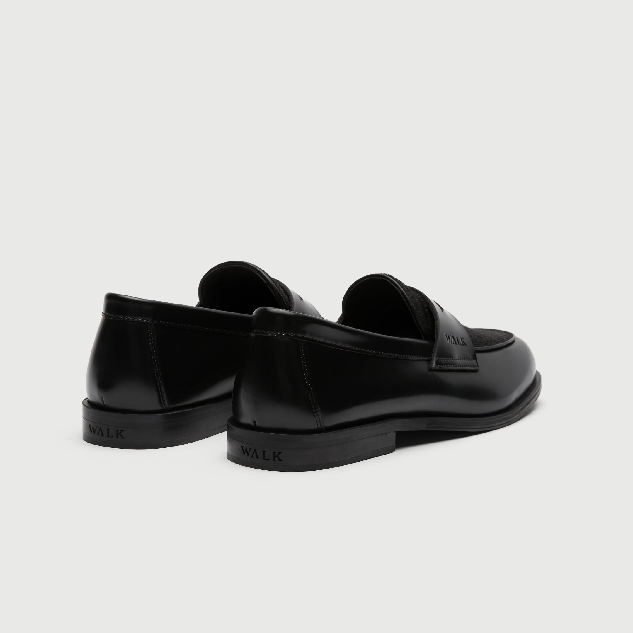 Walk London Grosvenor Saddle Loafers black leather with black pony hair vamp heel view showing debossed branding on heel of sole