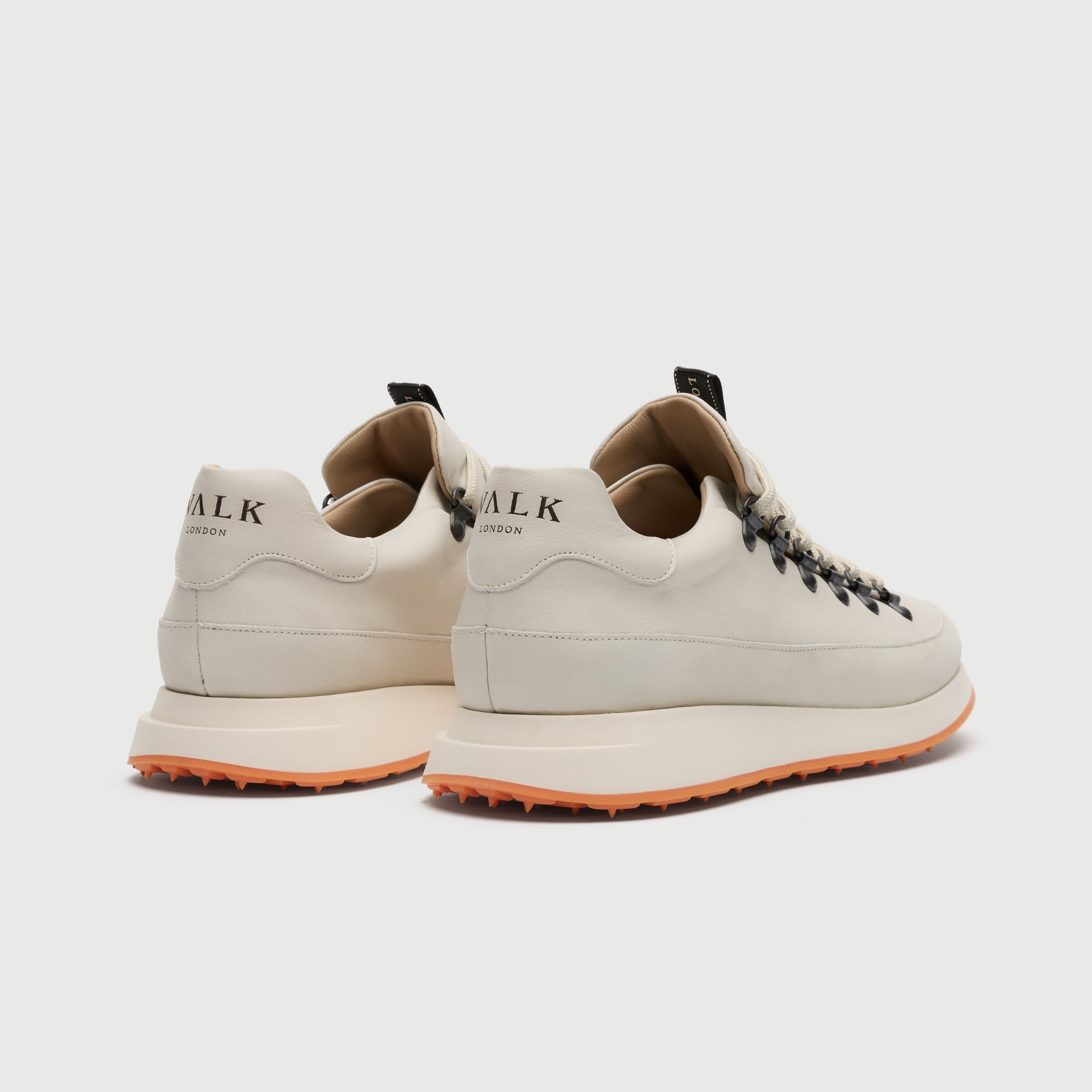 Back view of a Walk London Hampstead Hiking Trainer with an orange sole on a light grey background