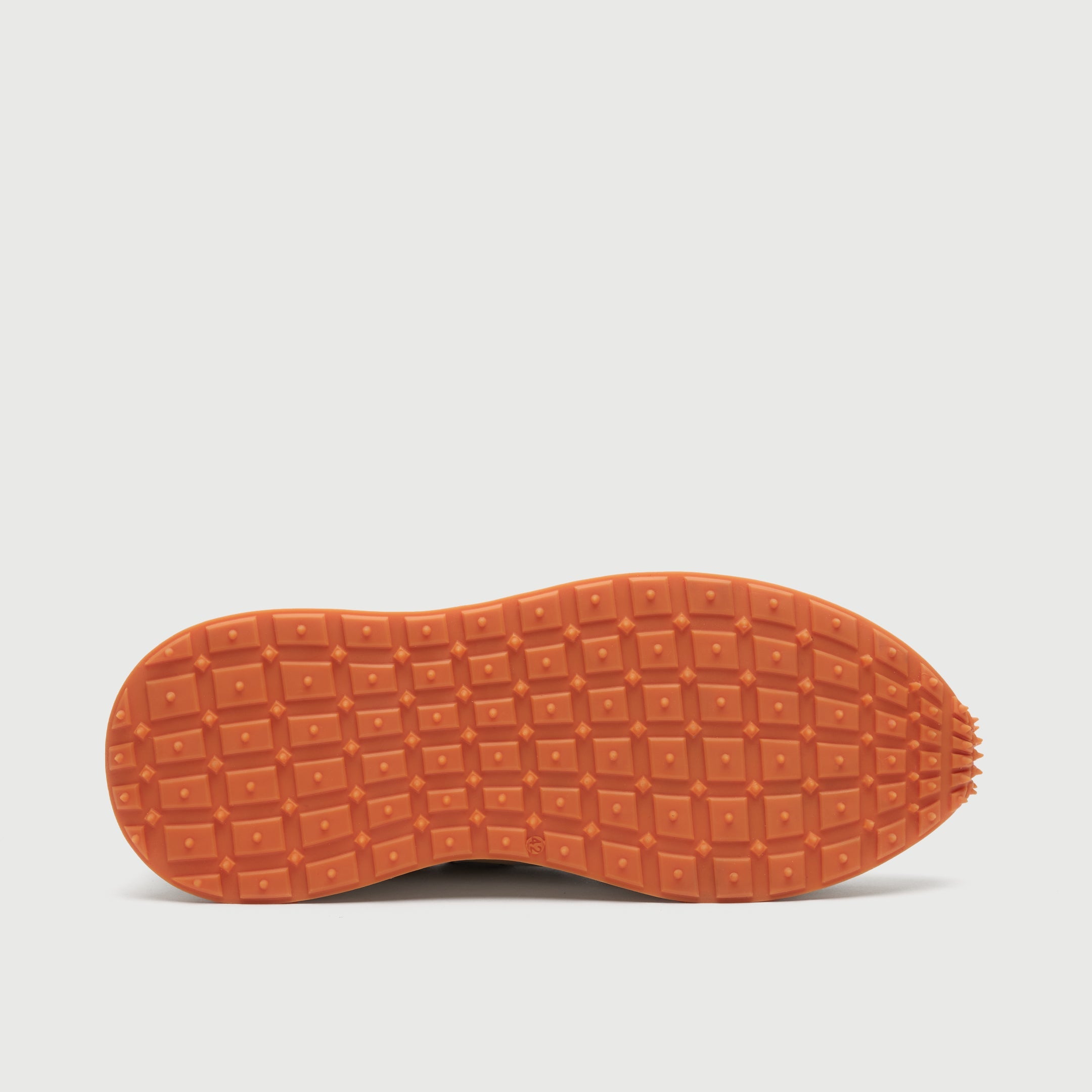 Sole Bottom view of a Walk London Hampstead Hiking Trainer with an orange sole on a light grey background