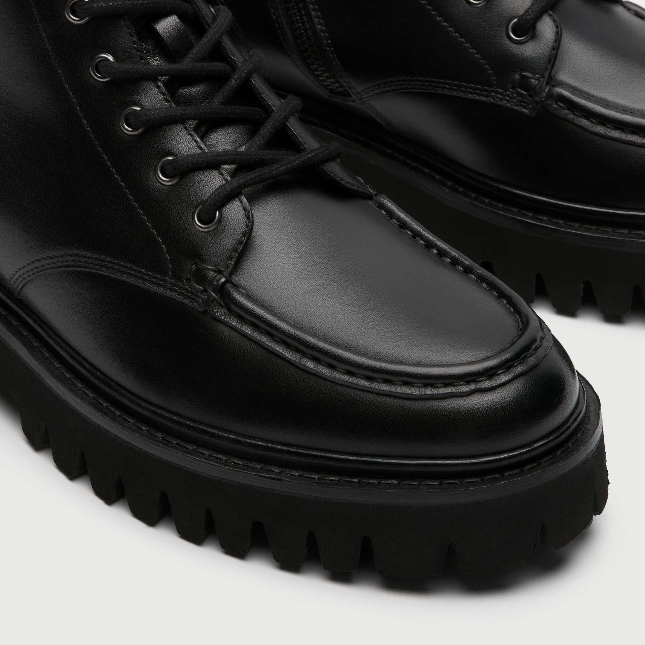 Close up of a Walk London Hopper Apron boot on a light Gray background