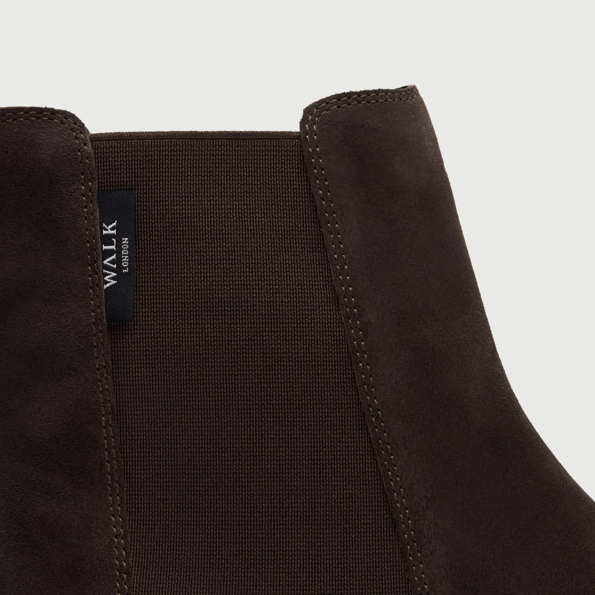 Walk London Hopper Chelsea Boot in Brown Suede close up of elastic panel, stitch detail, and branded label