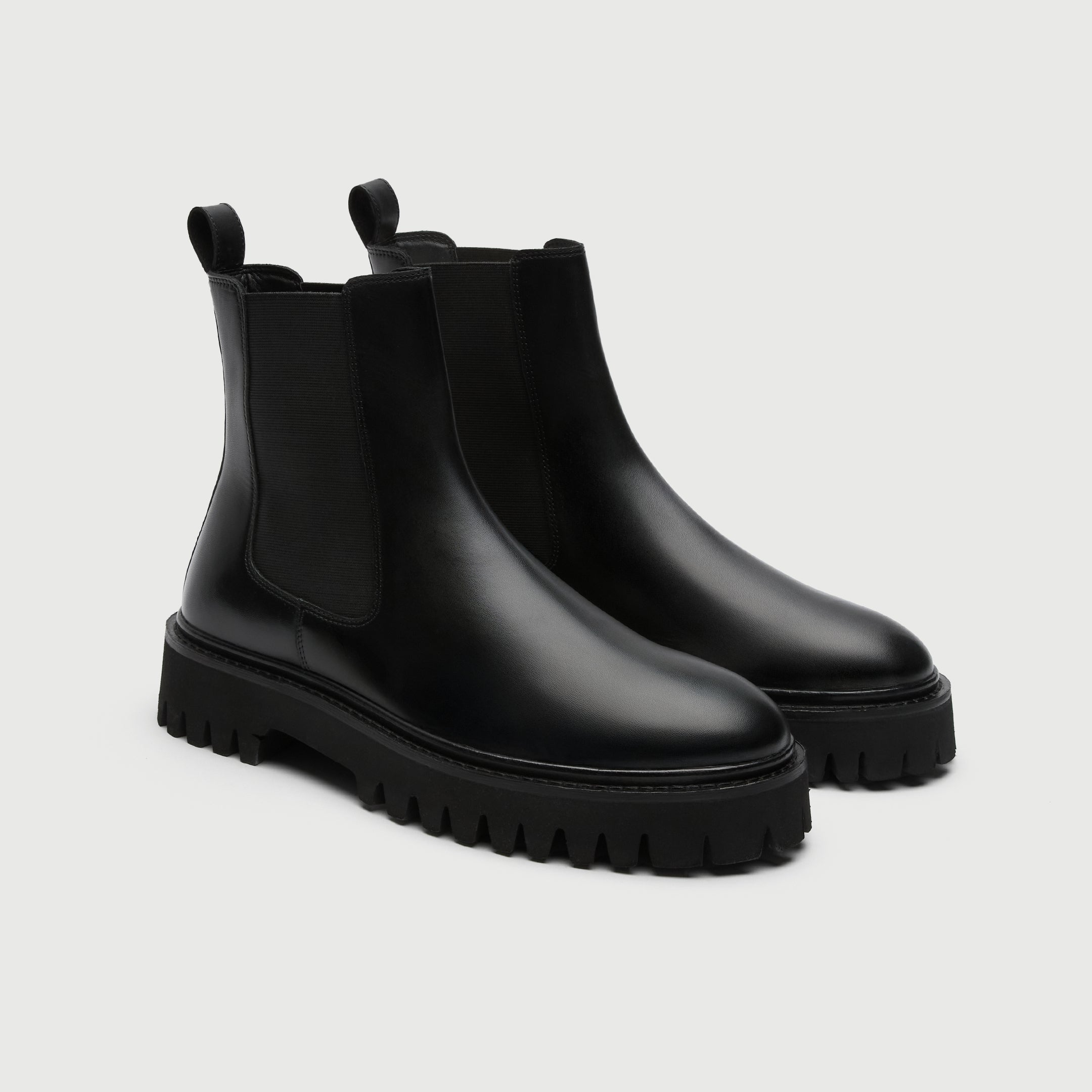 Pair of black rubber boots from Walk London Shoes on a light grey background
