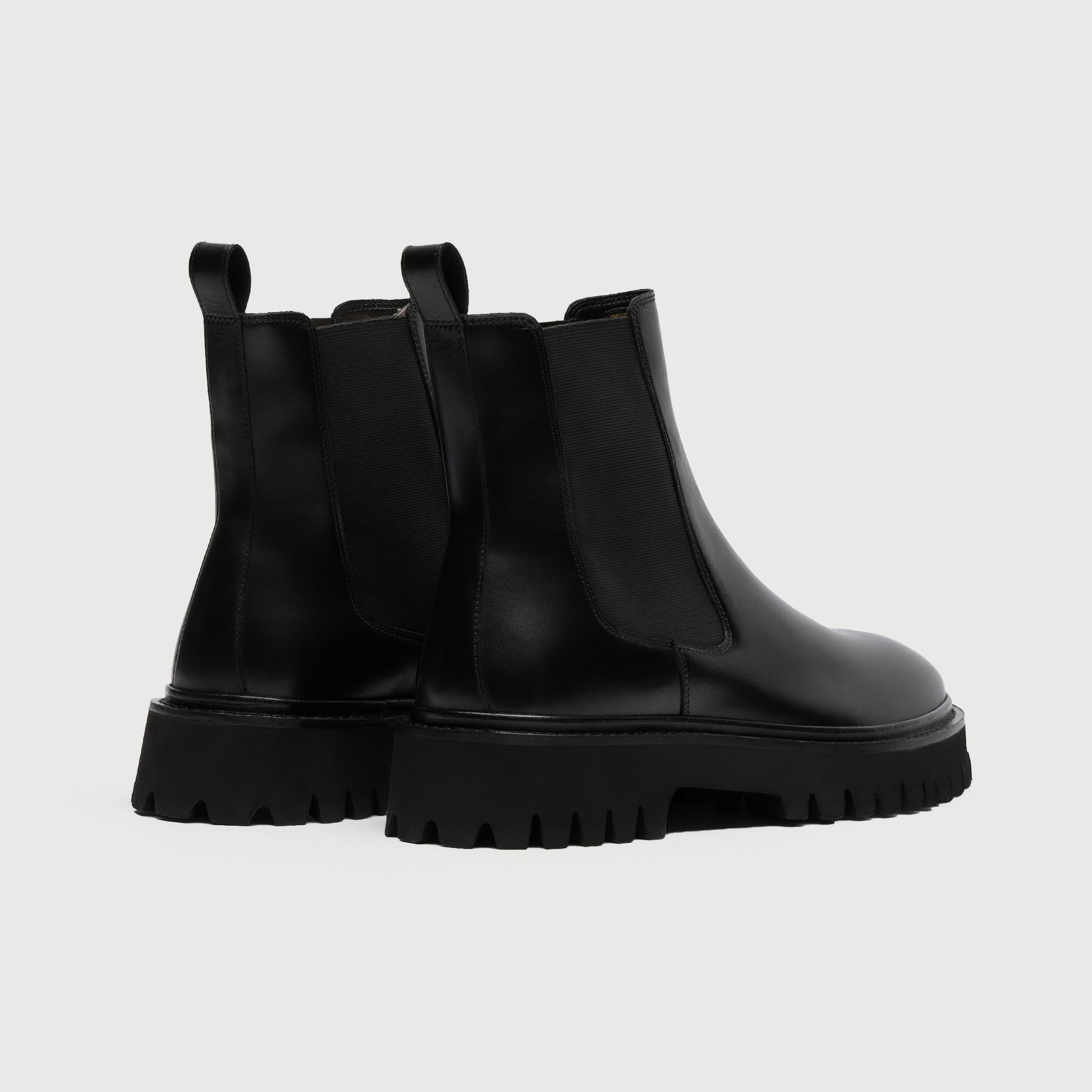 Pair of black rubber boots from Walk London Shoes on a light grey background