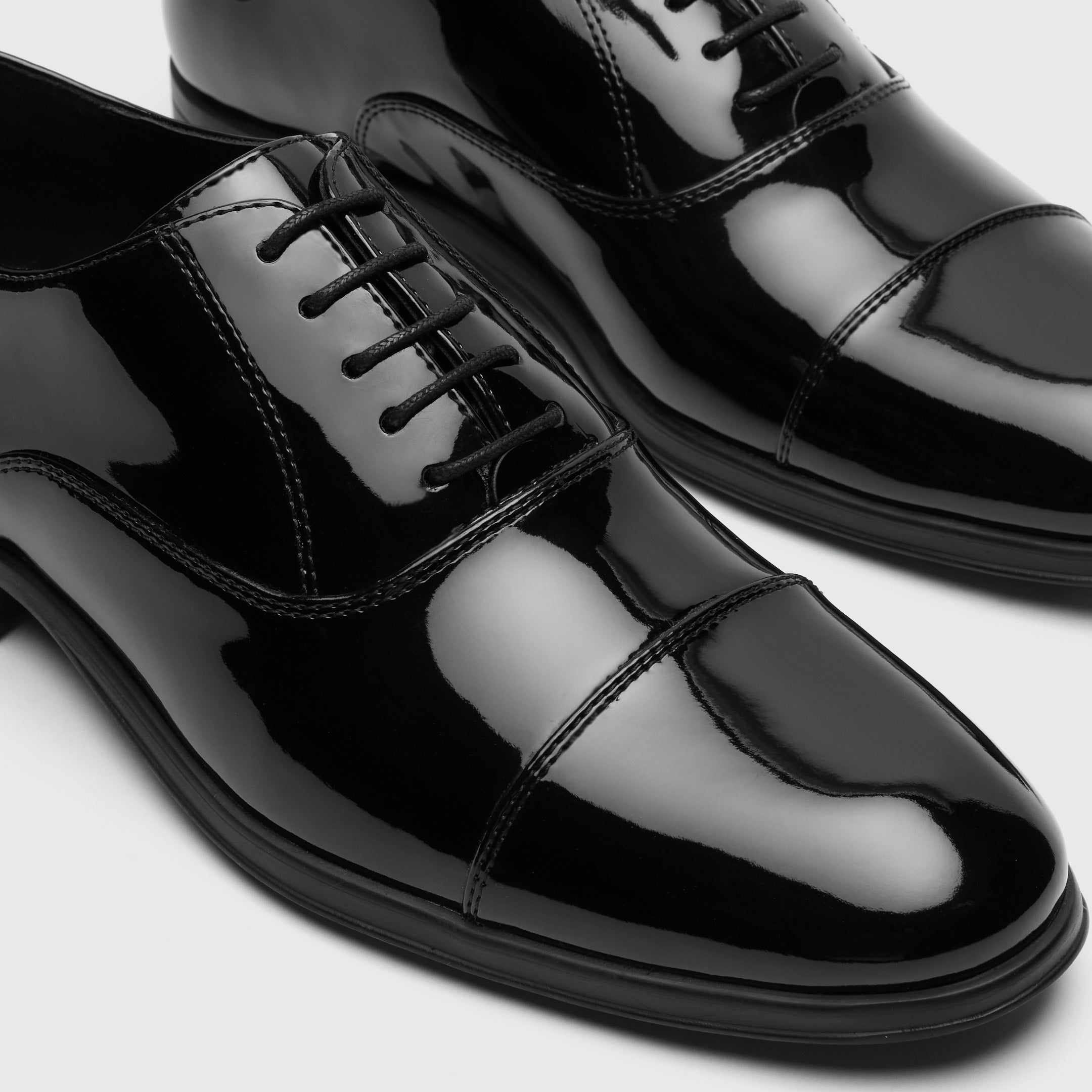 Walk London Oscar Black patent leather dress shoe on a light gray background