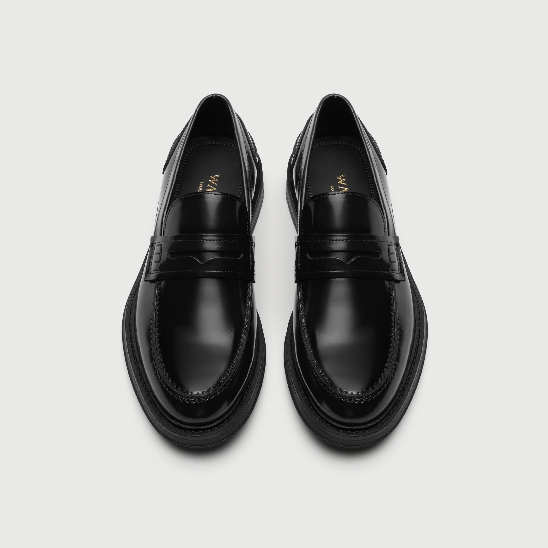 Pair of black loafers on a light gray background - Walk London Parsons Saddle Loafer in Black Leather Top View