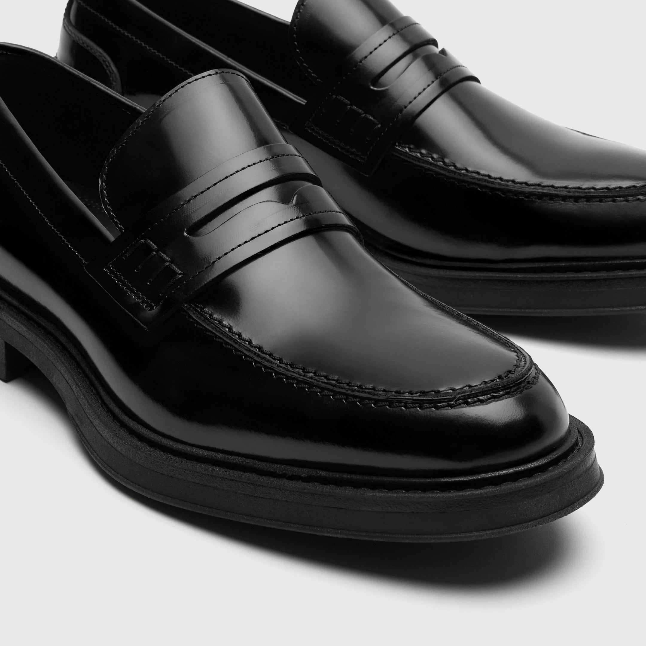 Black dress shoes on a light gray background - Walk London Parsons Saddle Loafer in Black Leather Toe View