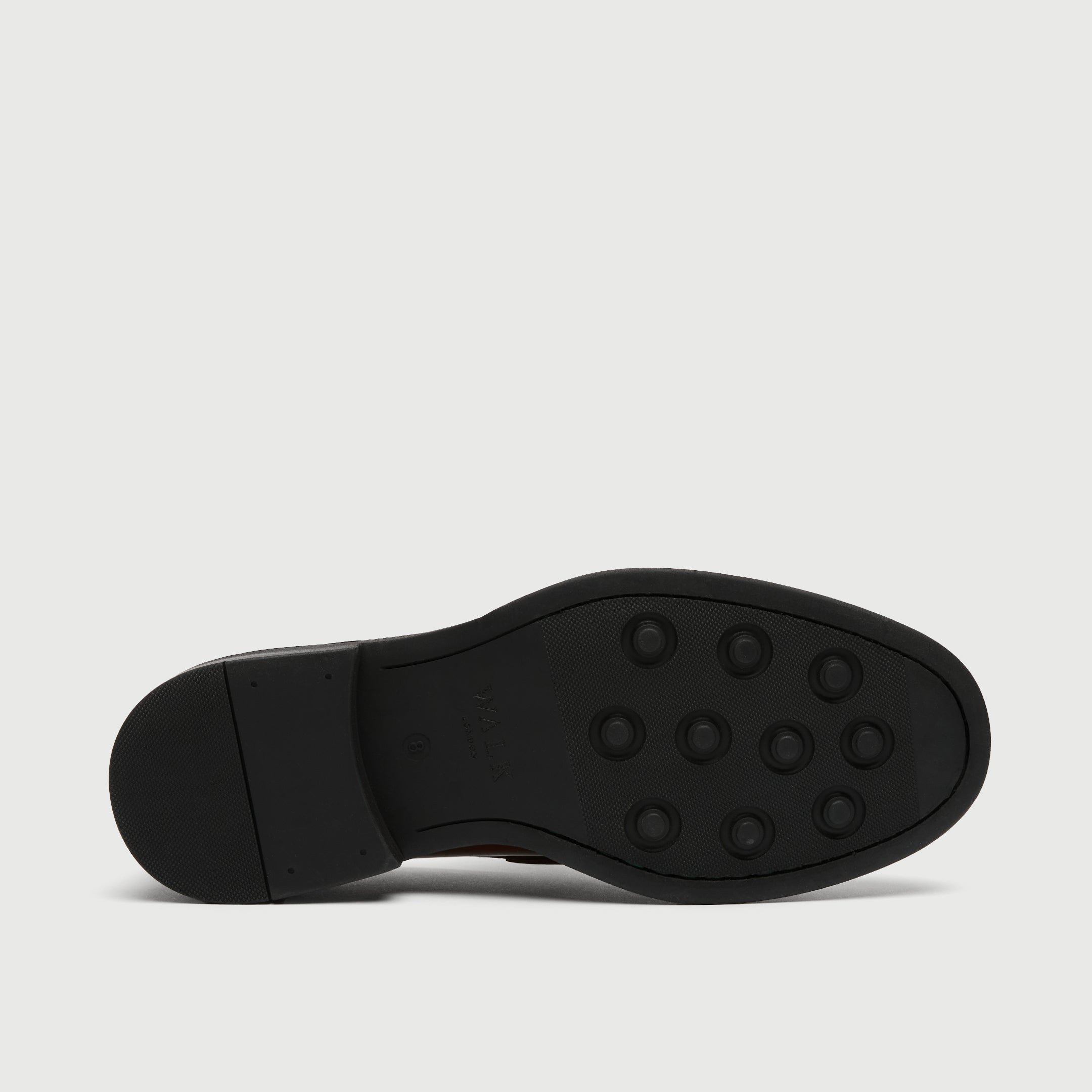 Black shoe sole on a light gray background - Walk London Parsons Saddle Loafer in Tan Leather