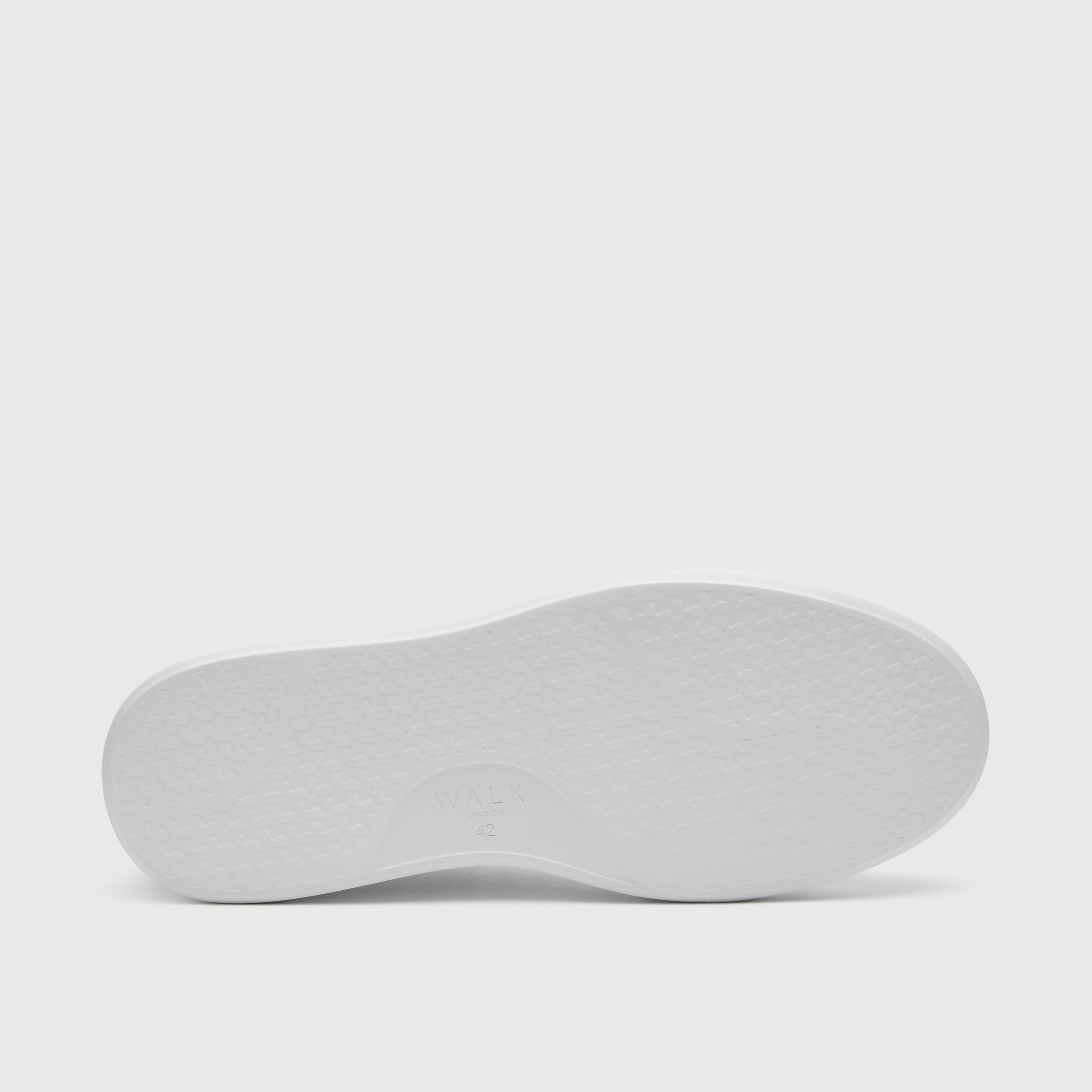 White shoe sole on a light gray background - Walk London Pasadena Trainer in White Leather