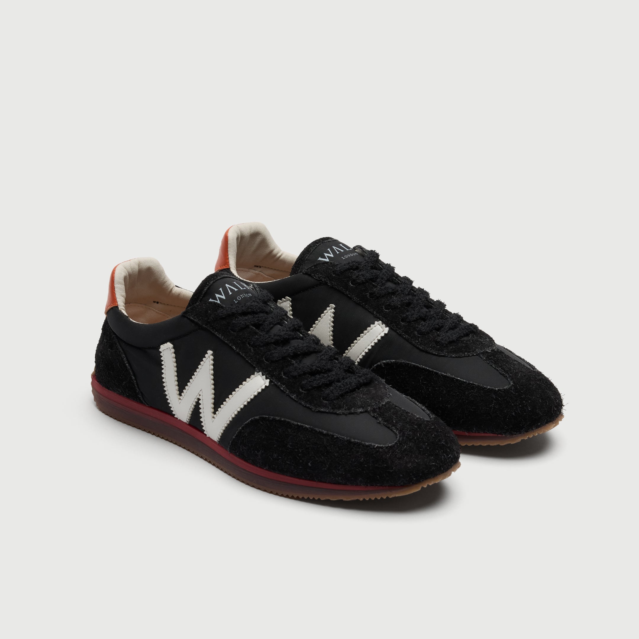 Walk London Retro Runner Trainers in Black Brushed Suede and Textile three quarter view showing seven eyelets with black hairy laces and white branding on tongue