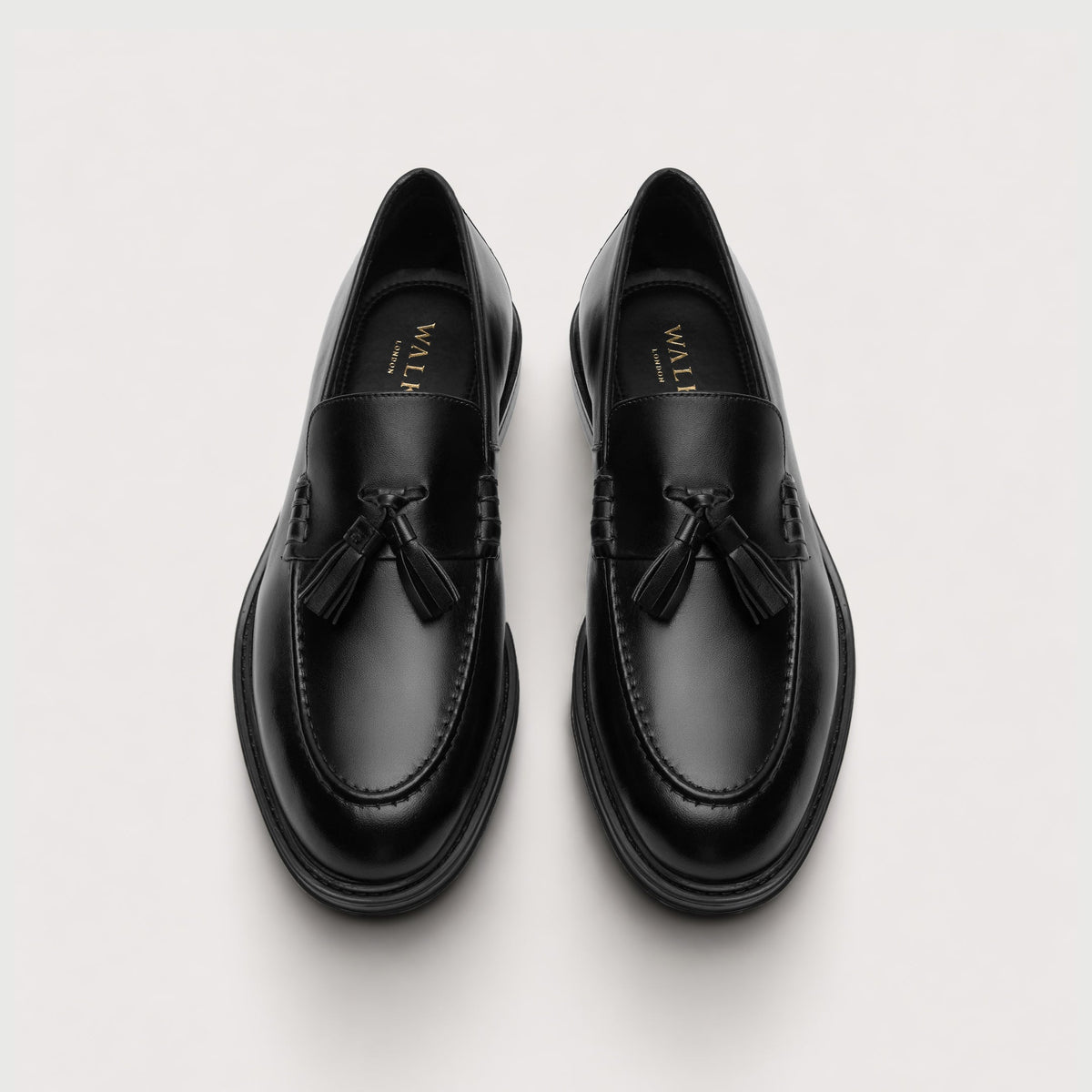 Walk London Richmond Tassel Loafers in Black Leather top view showing rounded toe shape and gold foil branding on black insoles