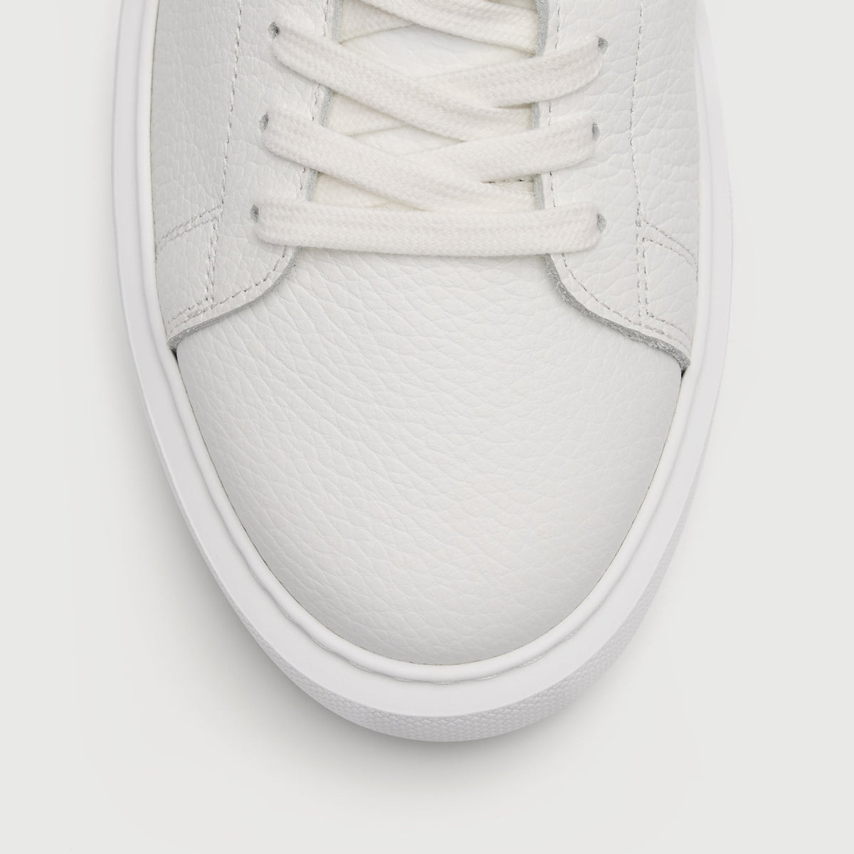 Walk London Wimbledon Trainer in White Grain Leather close up of grain texture on toe and flat white laces