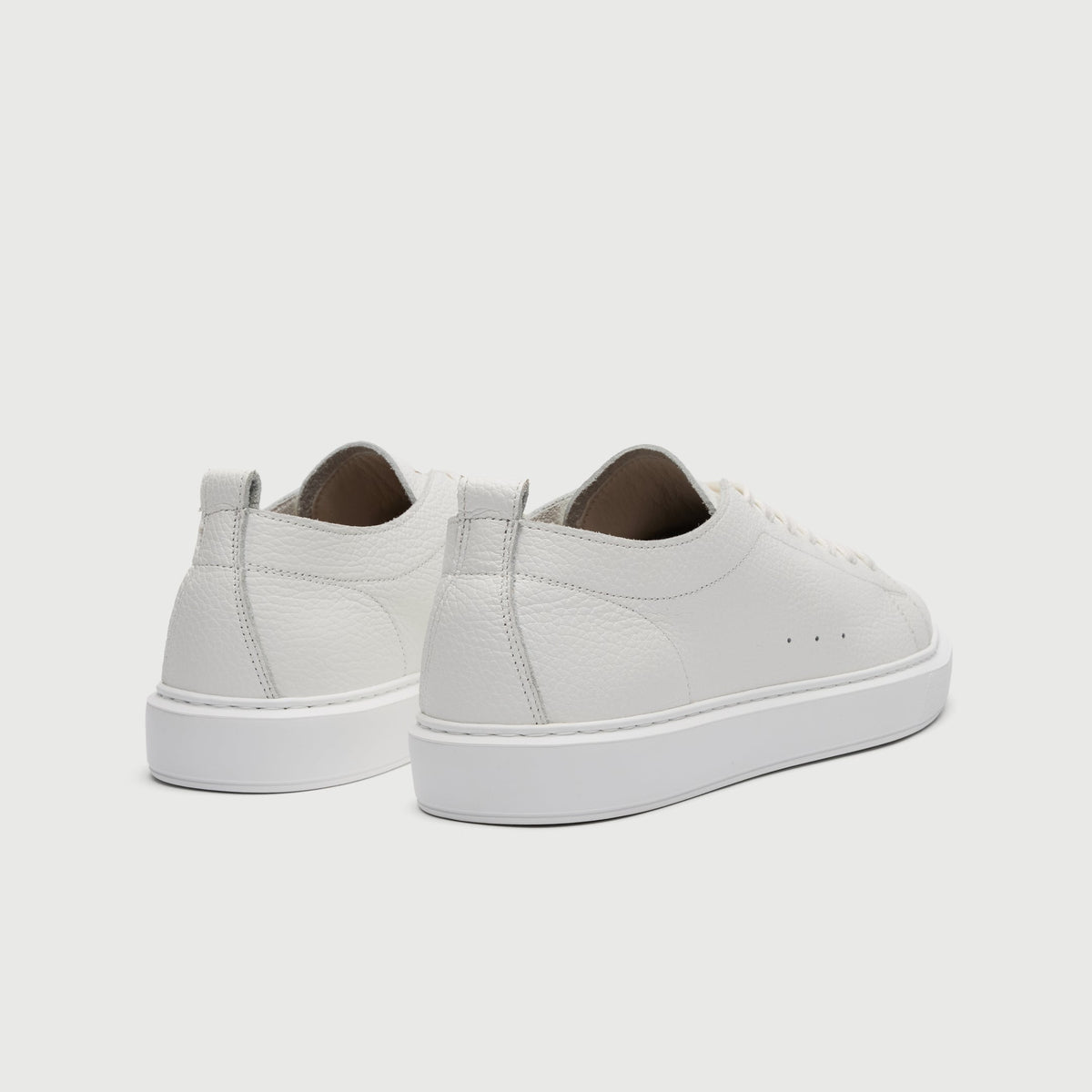Walk London Wimbledon Trainers in White Grain Leather heel view showing pull tab and vent holes on the side