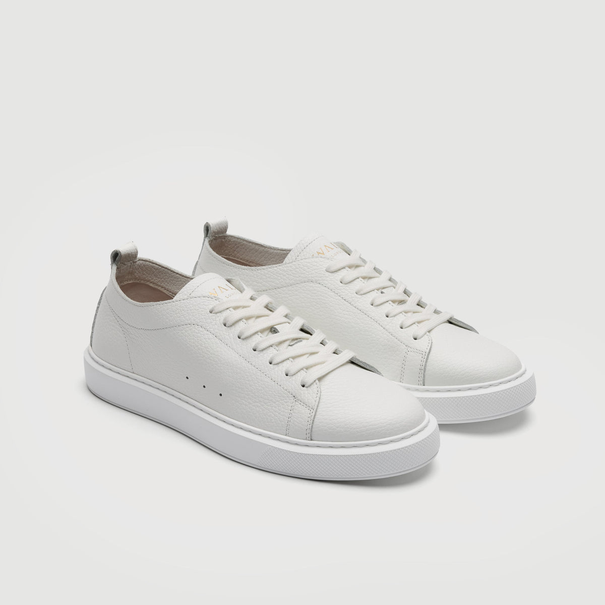 Walk London Wimbledon Trainers in White Grain Leather three quarter view showing gold foil branding on tongue and seven eyelet fastening with white laces