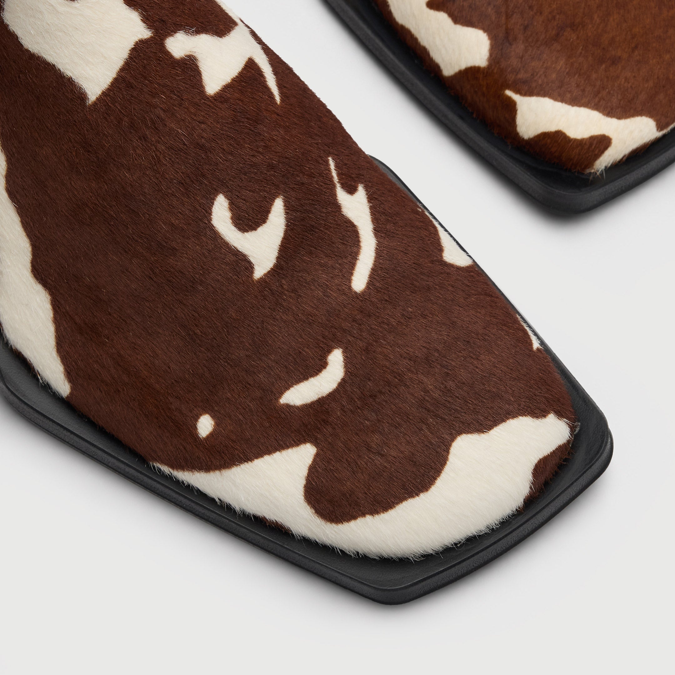 Walk London Abbey Zip Up Cuban Heel Ankle Boots in brown and white cow print hair on leather close up view of the toe with squared sole