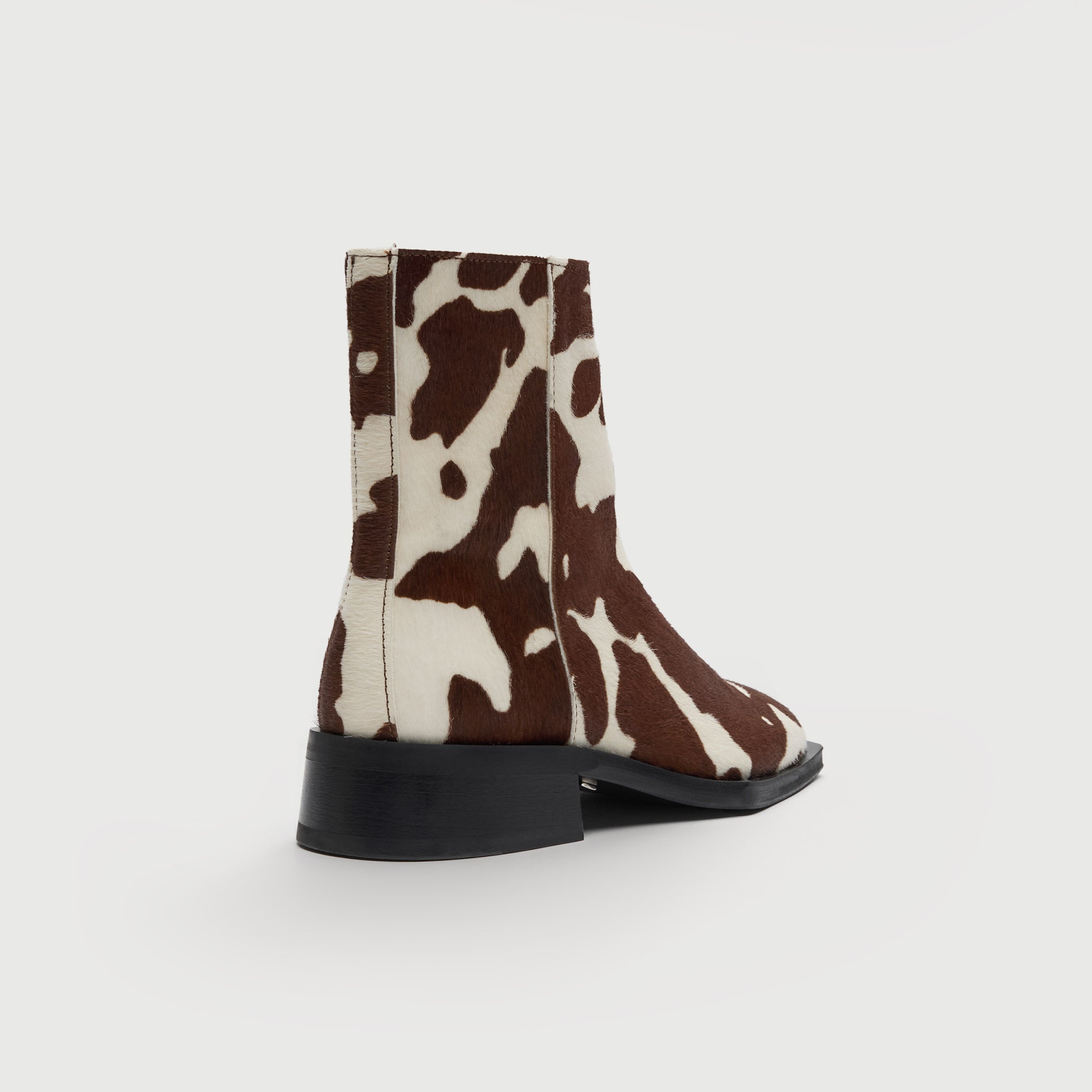 Walk London Abbey Zip Up Cuban Heel Ankle Boots in brown and white cow print hair on leather heel view