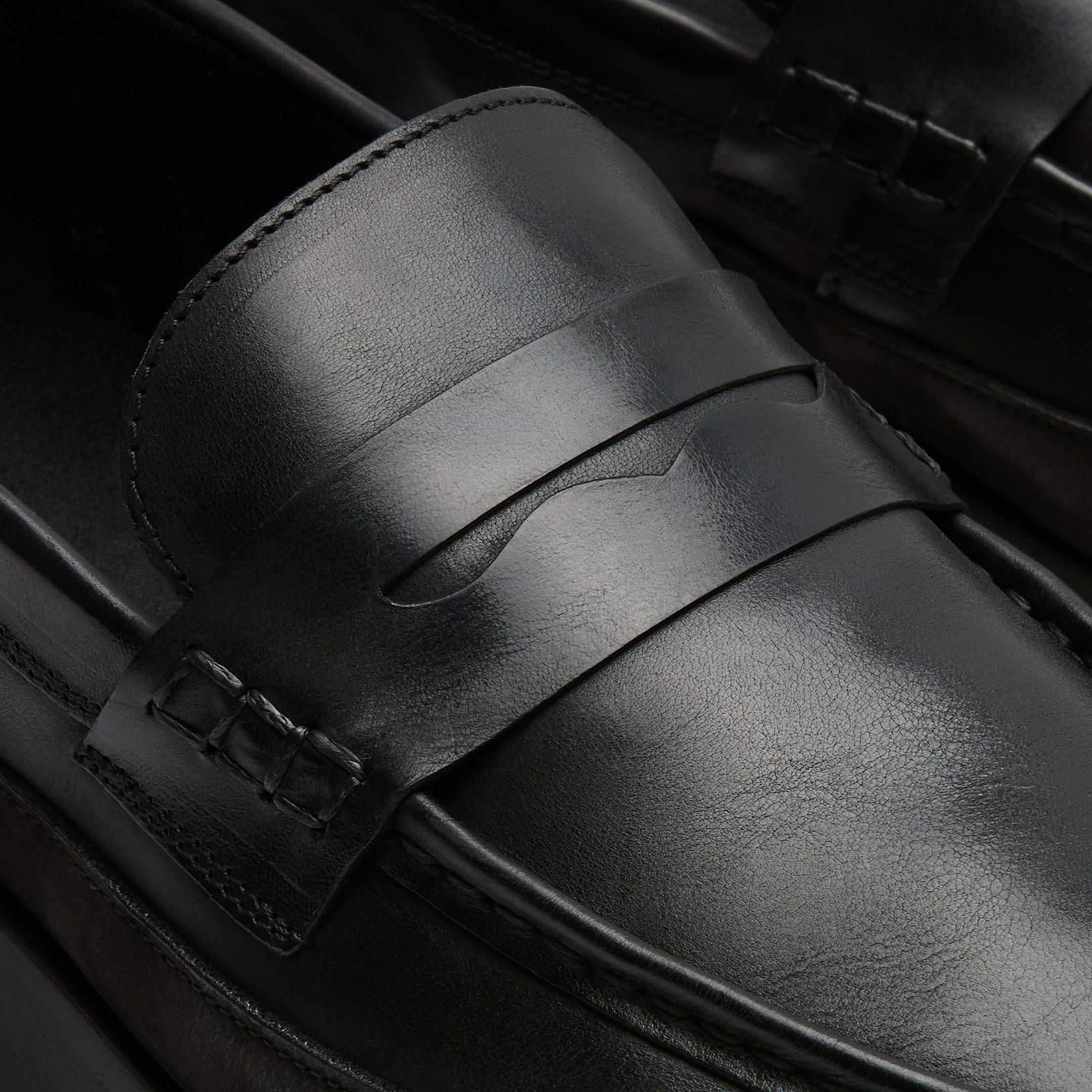 Walk London Battersea Saddle Hybrid Loafer in black leather close up of saddle strap and beefroll stitching
