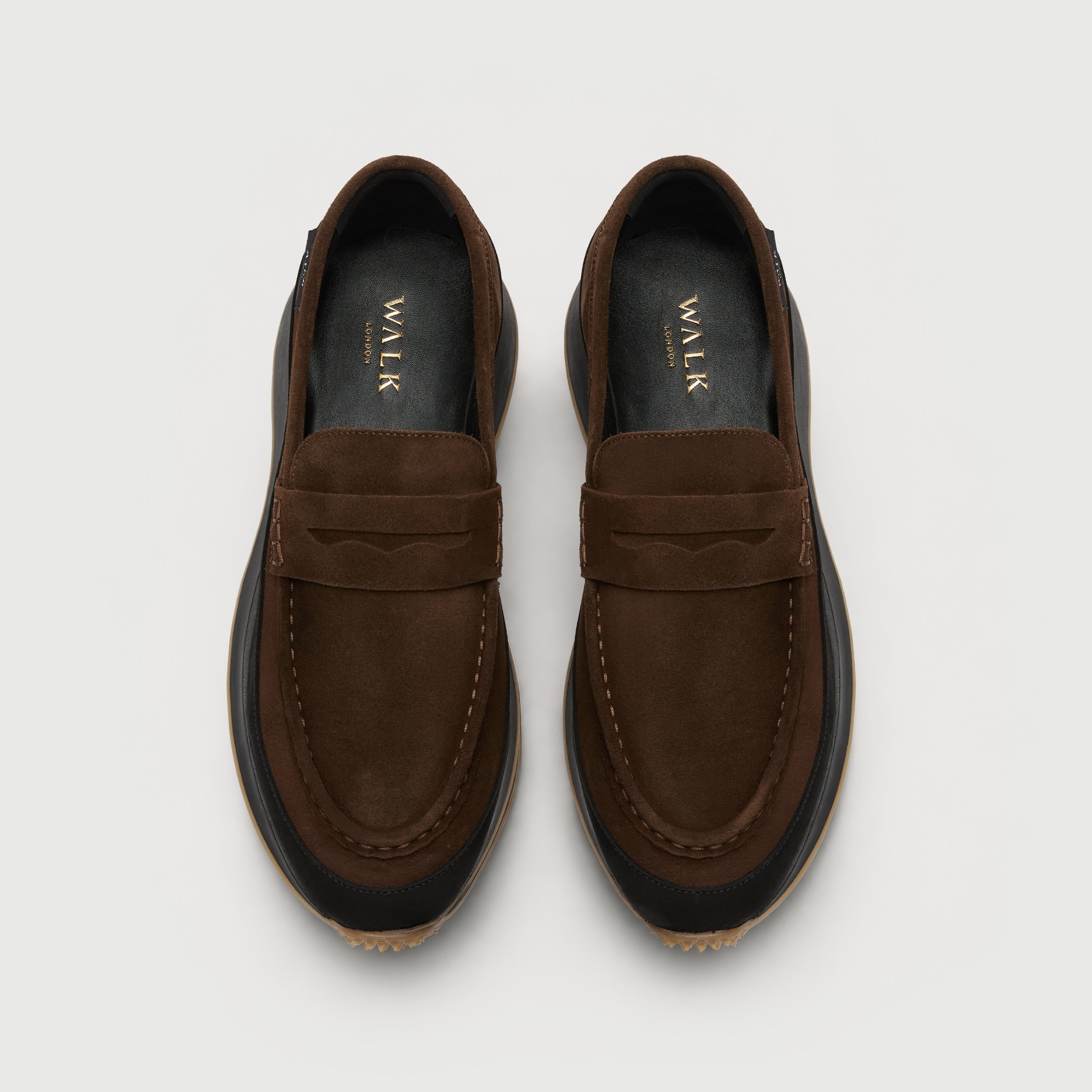 Walk London Battersea Saddle Hybrid Loafer in brown and black suede top view showing gold branding on leather insole