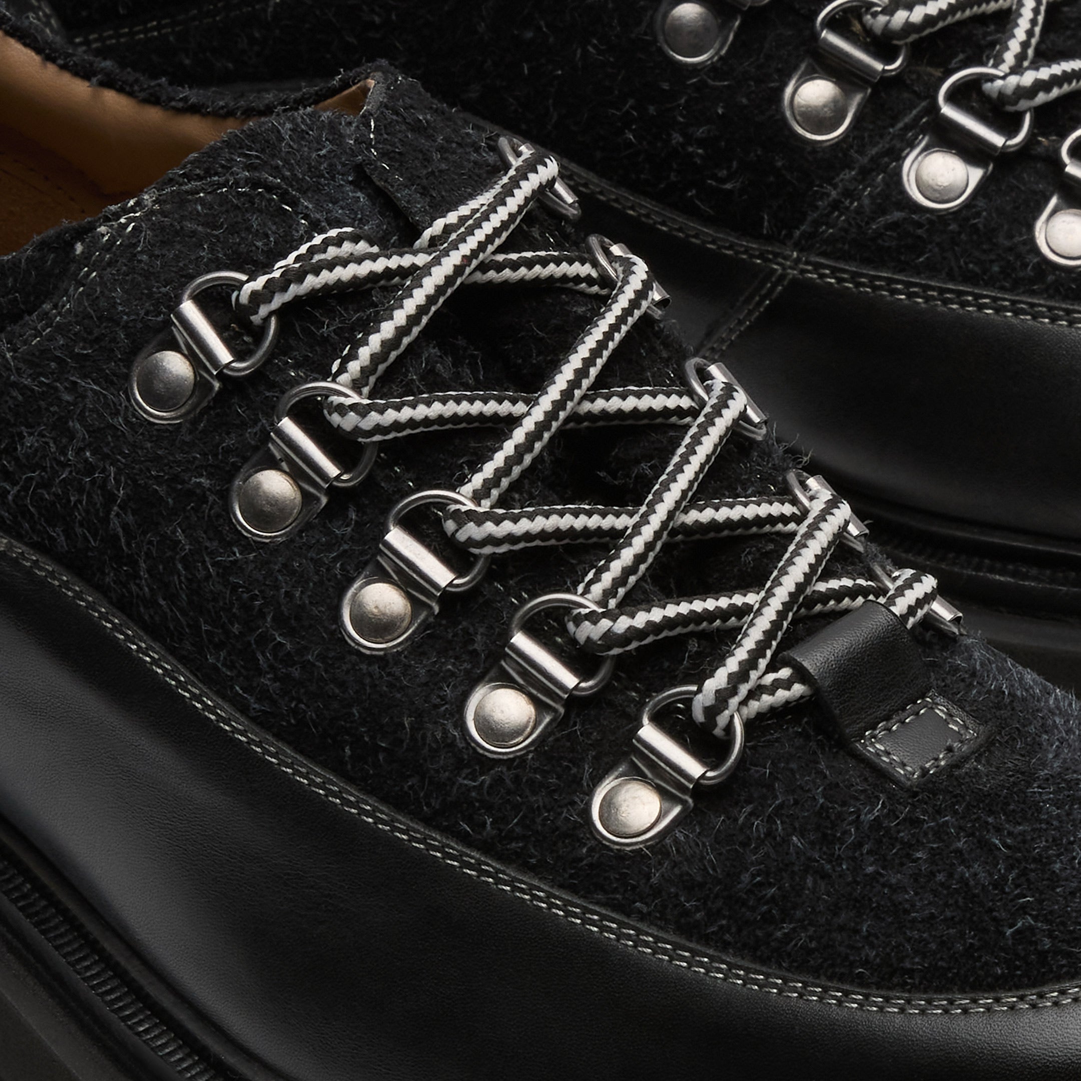 Walk London Bethnal Hiking Shoes in black leather and hairy suede close up view f black and white laces and D-rings