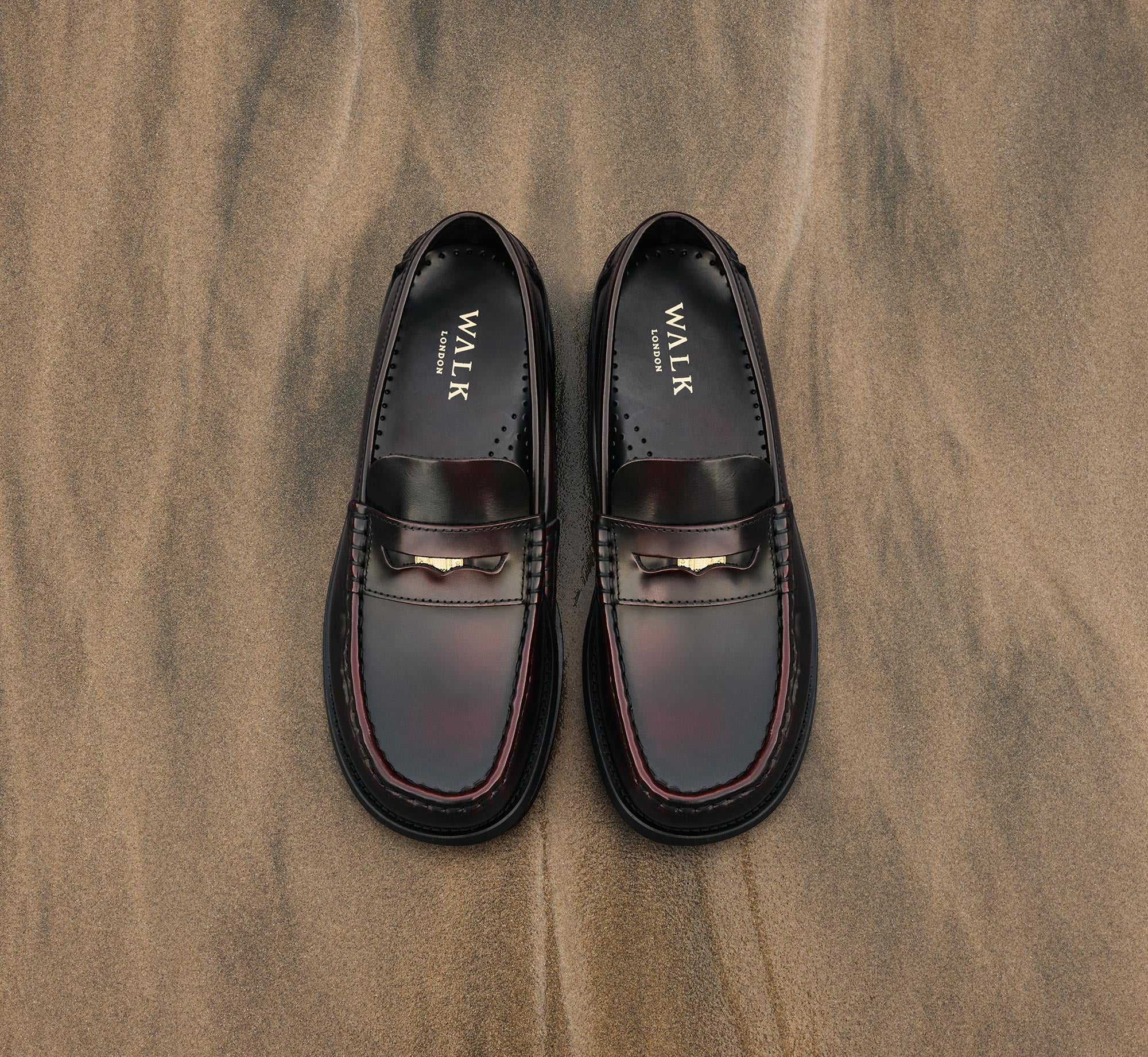 Shoreditch mens leather penny loafers in burgundy on sandy background
