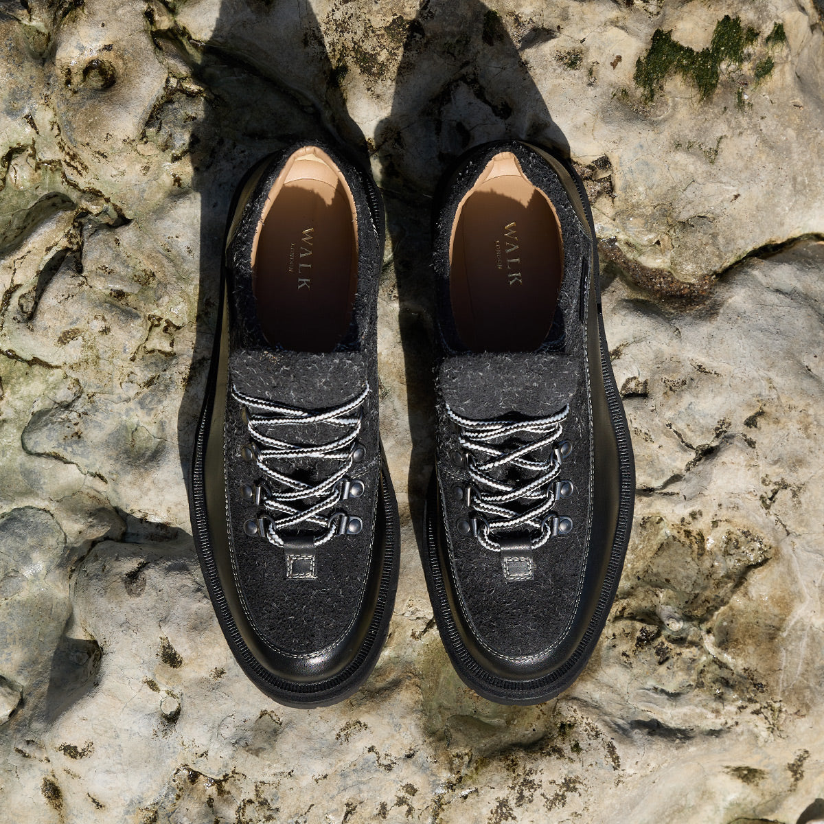 Bethnal black leather and textured suede mens hiking style shoes on light coloured rocks