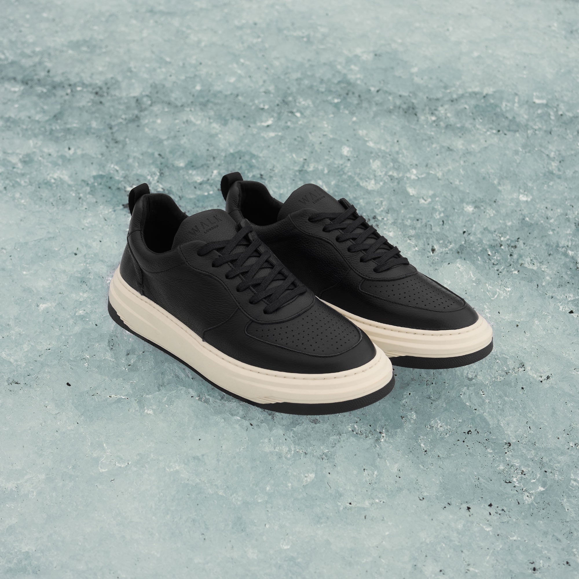 black and white mens leather trainers on ice glacier
