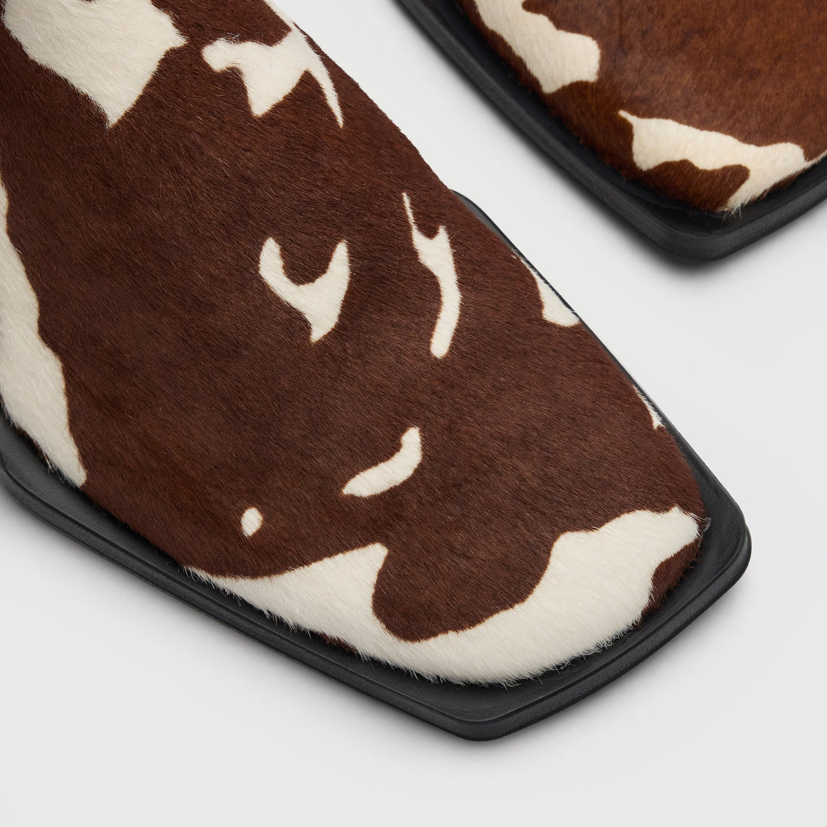 Walk London Abbey Zip Up Cuban Heel Ankle Boots in brown and white cow print hair on leather close up view of the toe with squared sole