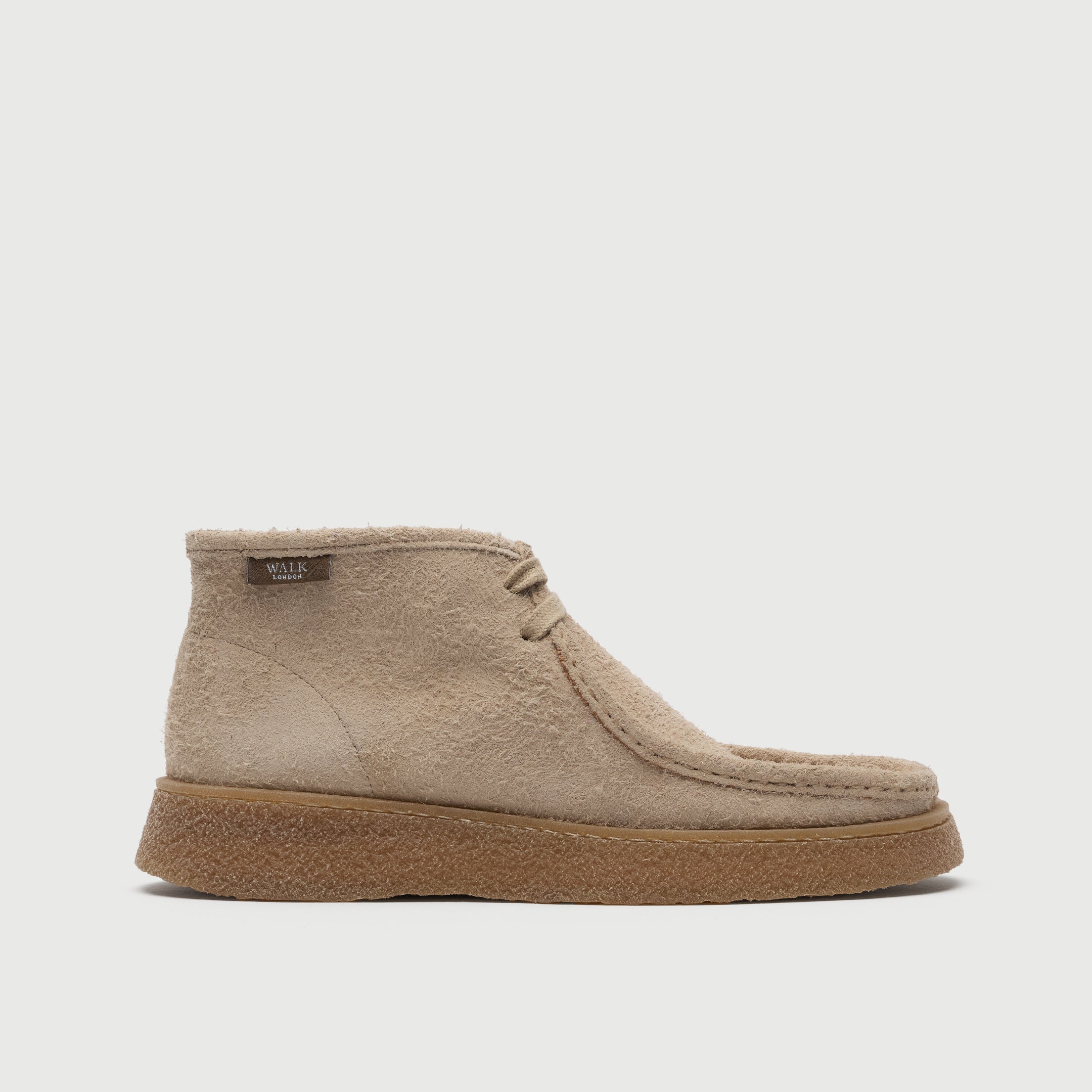 Beige suede shoe on a light grey background. Walk London Carnaby chukka boot side image