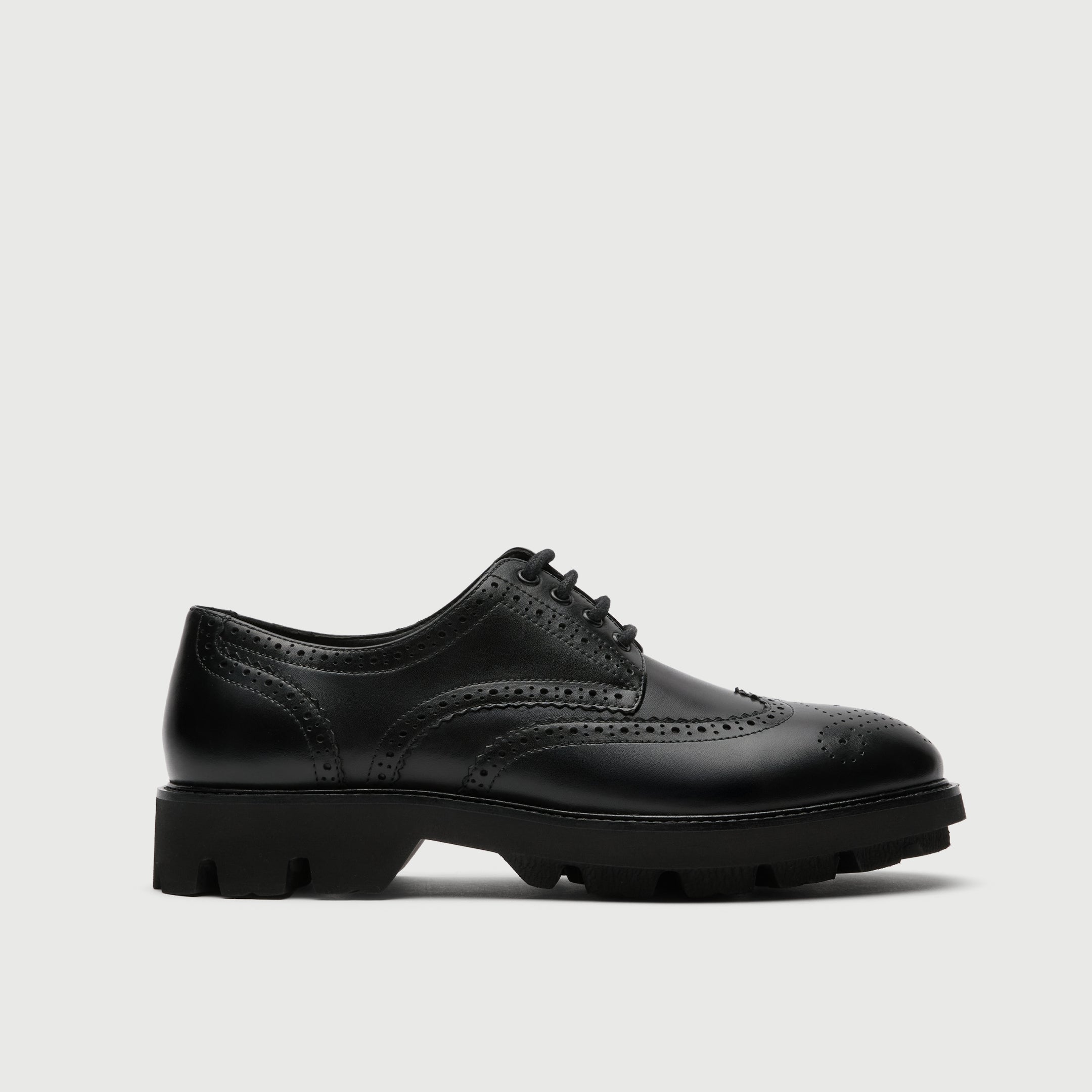 Black leather Walk London Felix brogue shoe on a light grey background