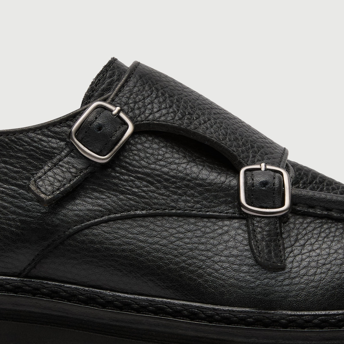 Walk London Finchley Double Monk Shoe in black grain leather close up view of strap with two silver-tone buckles