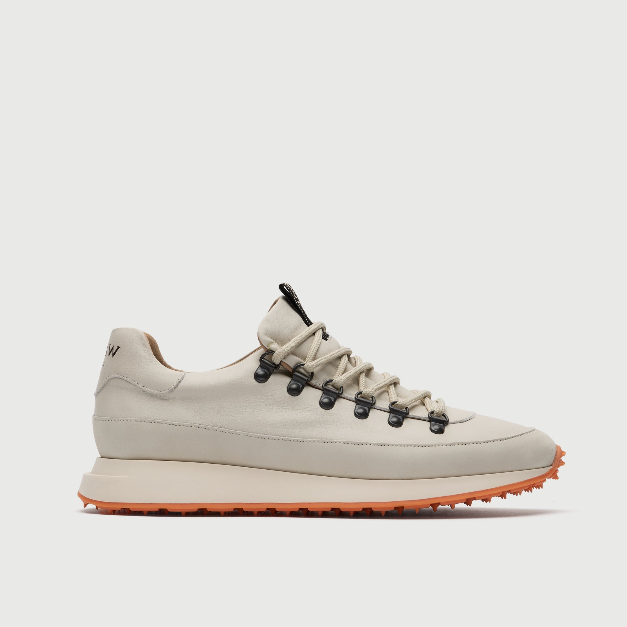 Side view of a Walk London Hampstead Hiking Trainer with an orange sole on a light grey background