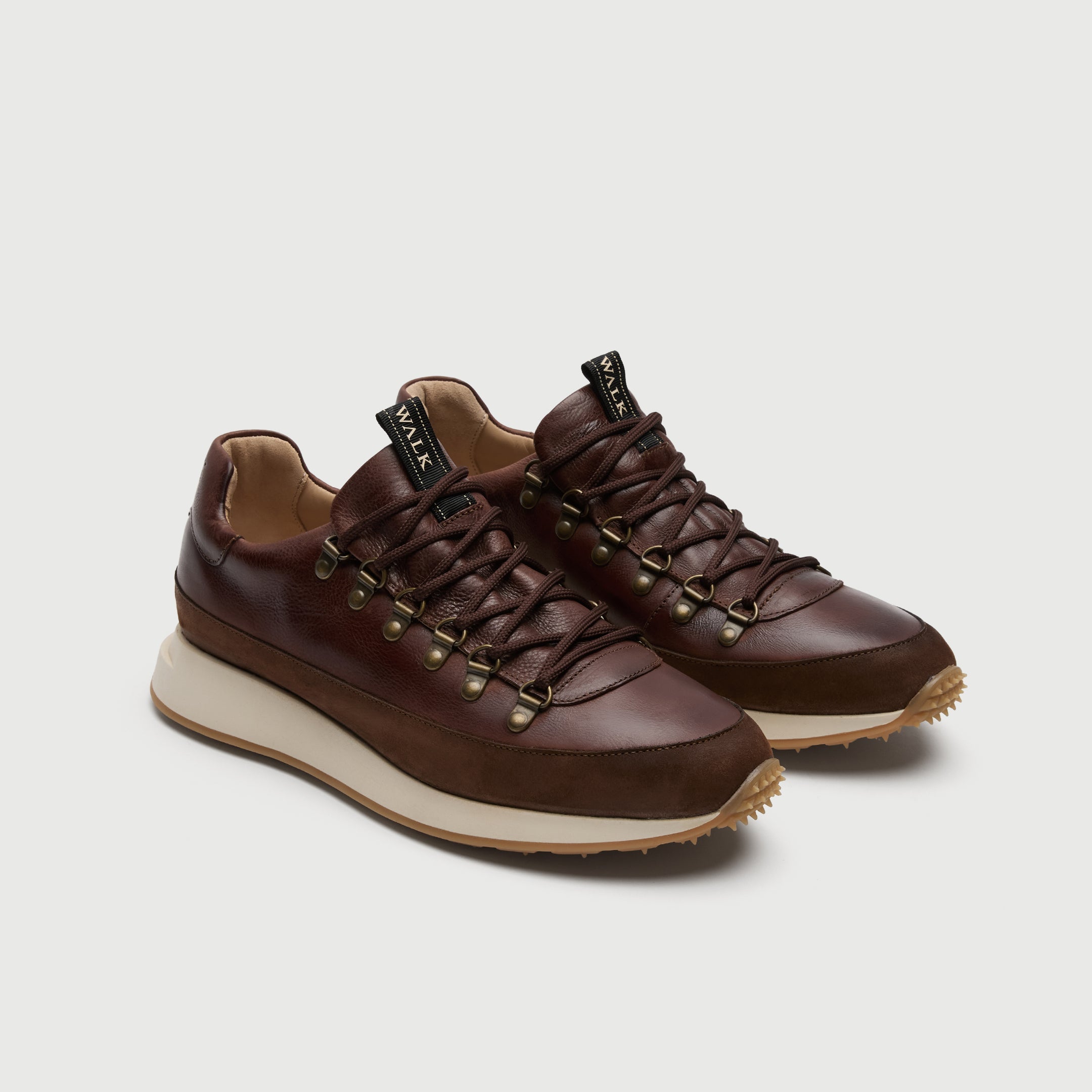 Walk London Hampstead Hiking Style Trainers in Brown Leather three quarter view showing brass toned d-rings and gold branded pull tab on tongue