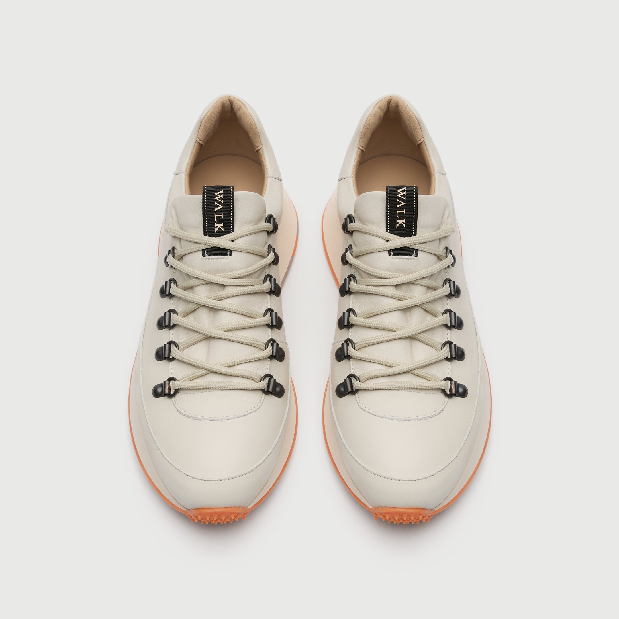 Top view of a Walk London Hampstead Hiking Trainer with an orange sole on a light grey background