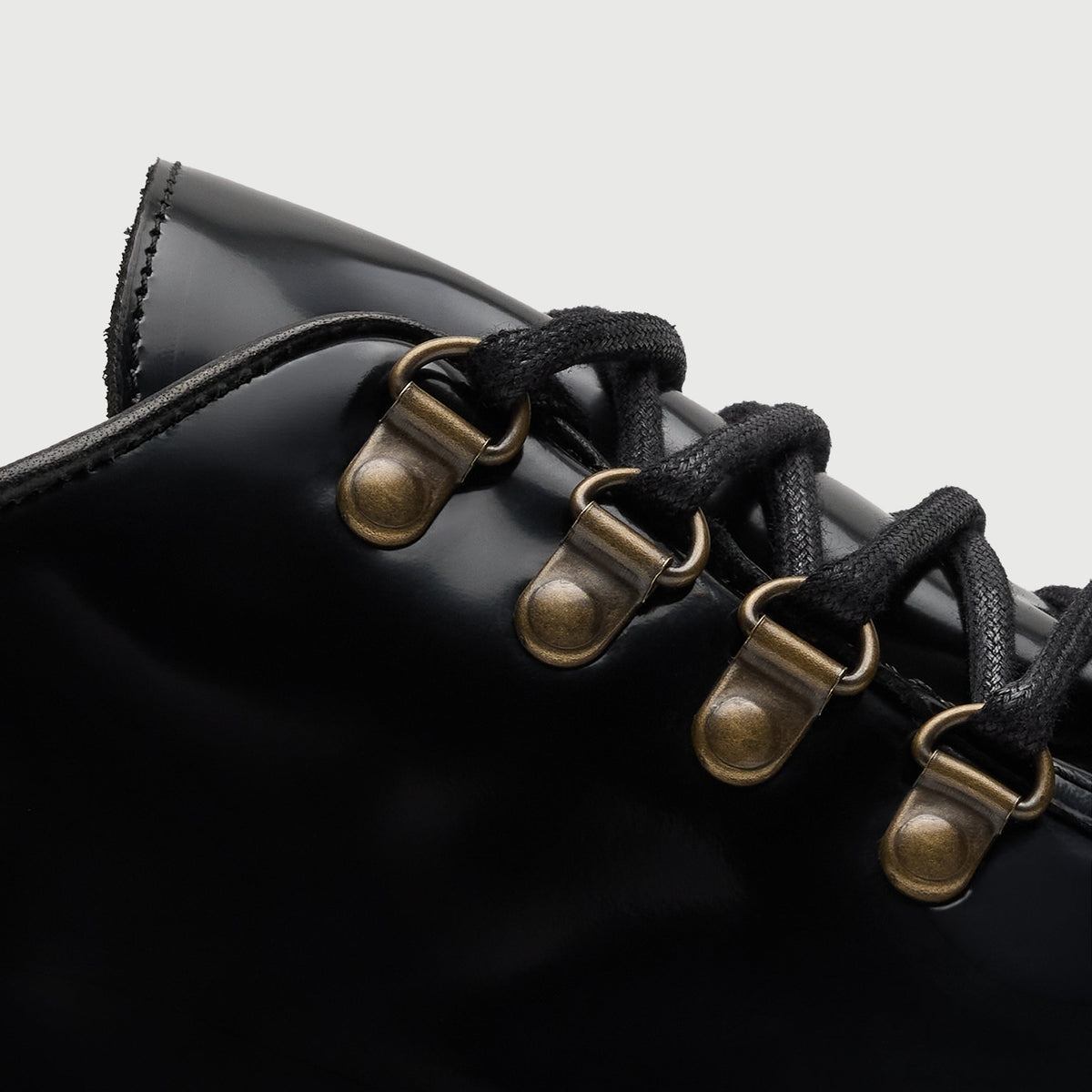 Walk London Hartford Hiking Style Shoes in black smooth leather detail view showing brass-toned d-rings and black laces
