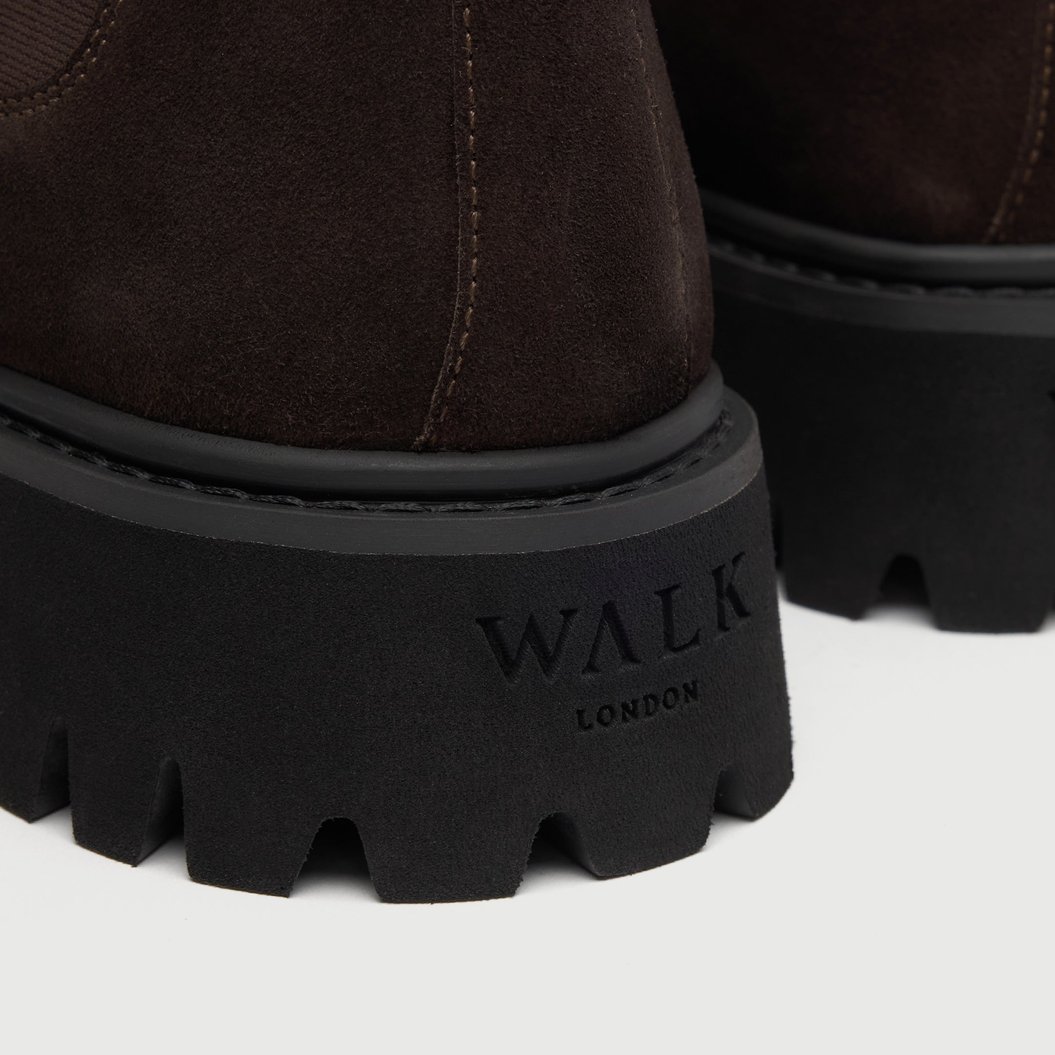 Walk London Hopper Chelsea Boots in Brown Suede close up view of debossed branding on heel of chunky sole
