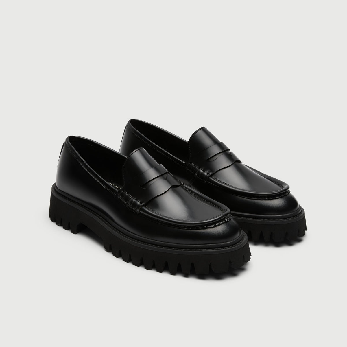 Walk London Hopper Saddle Loafers in Black Smooth Leather three quarter view showing cut out in the saddle strap, apron seam, beefroll stitch, and chunky sole