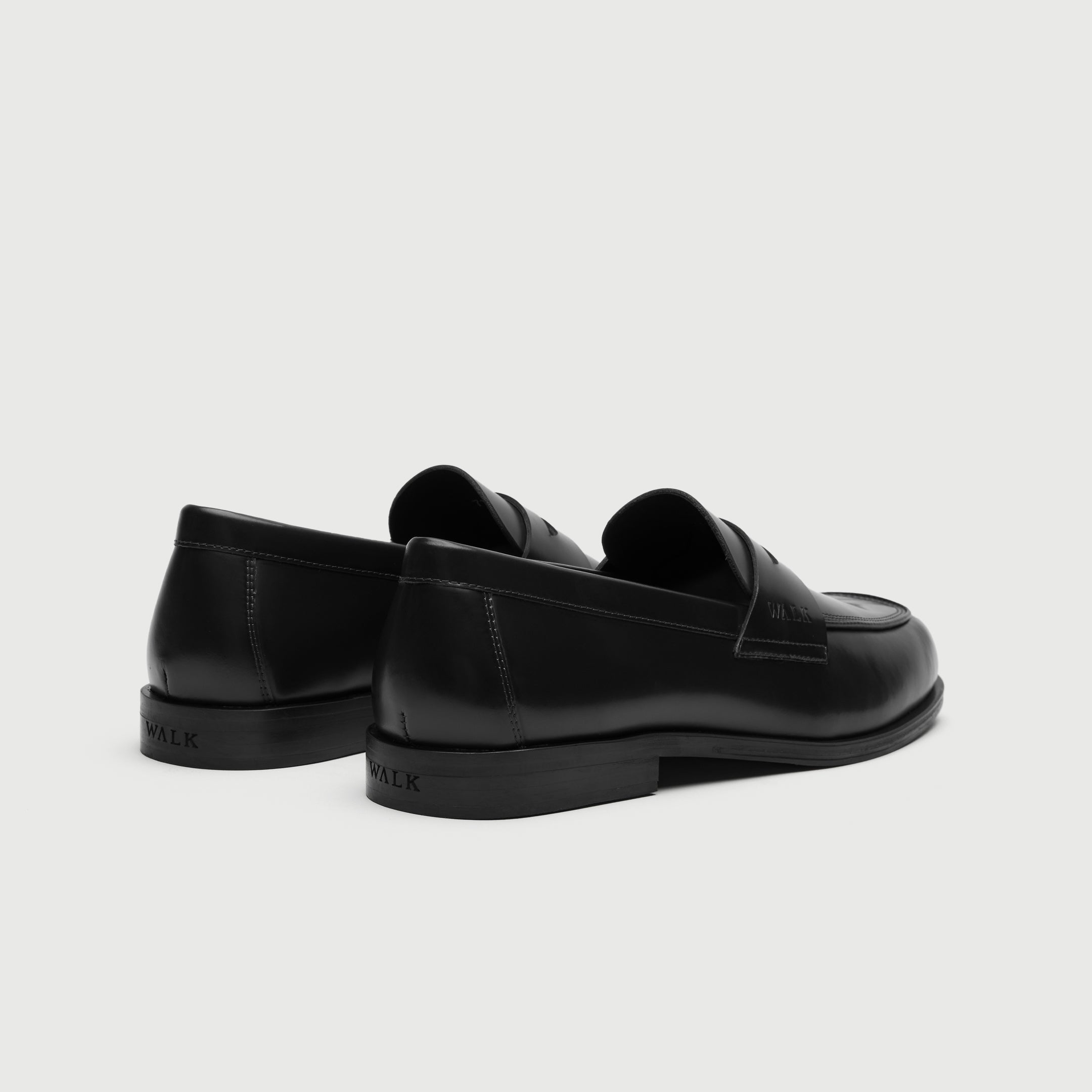 Walk London Marylebone Saddle Loafers in Black Leather heel view showing debossed branding on the heel of the sole
