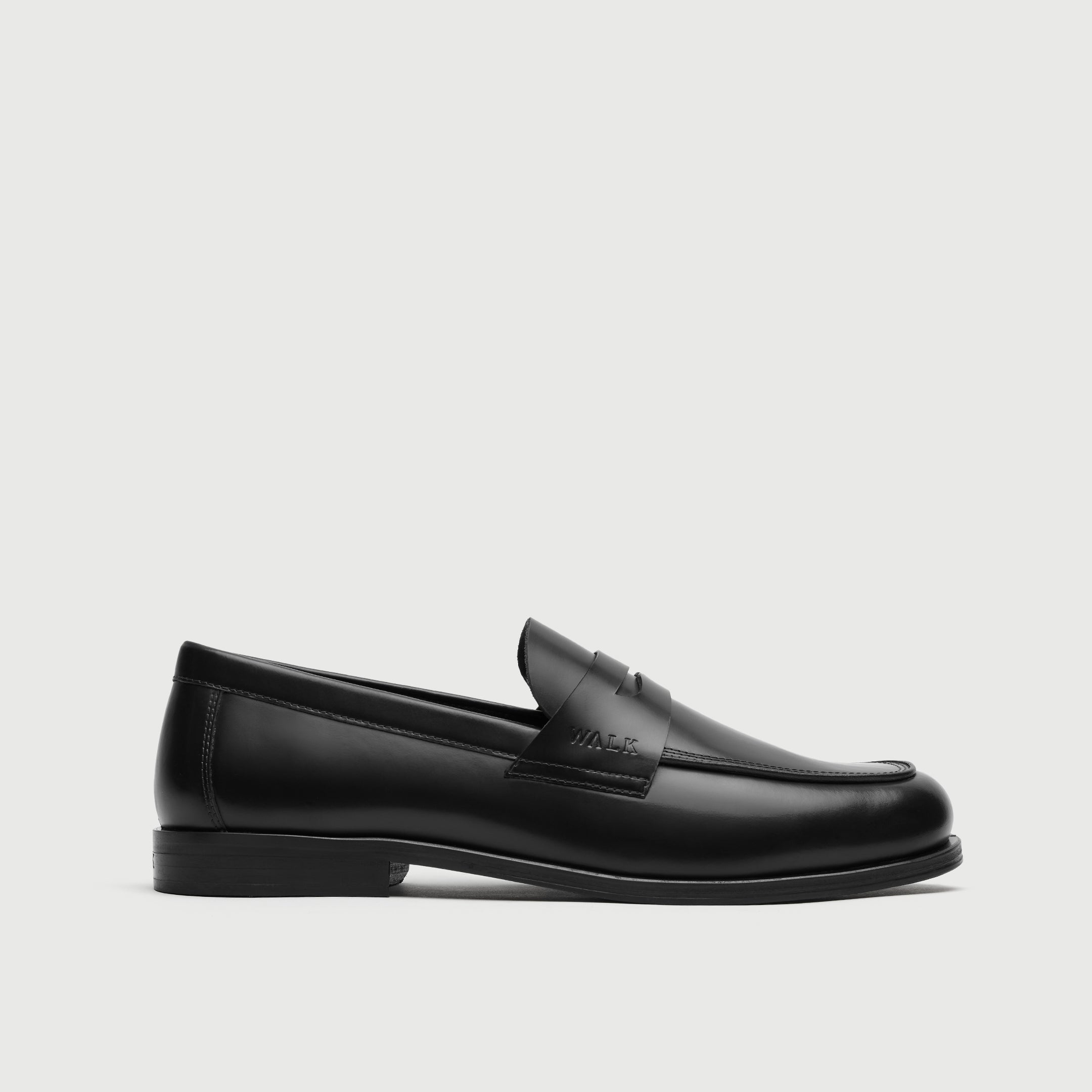 Walk London Marylebone Saddle Loafer in Black Leather side view showing debossed branding on the side of the saddle strap