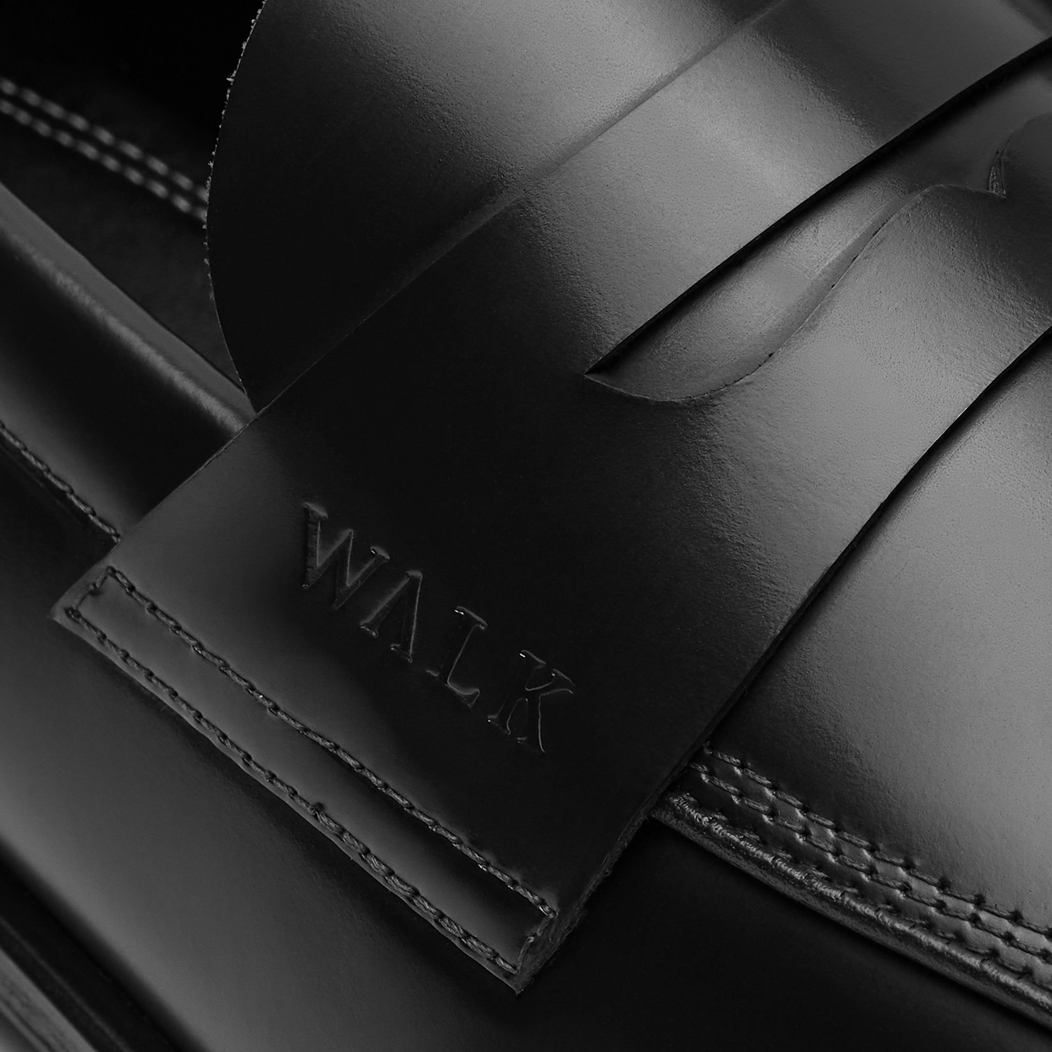 Walk London Marylebone Saddle Loafers in Black Leather close up of debossed branding and stitching
