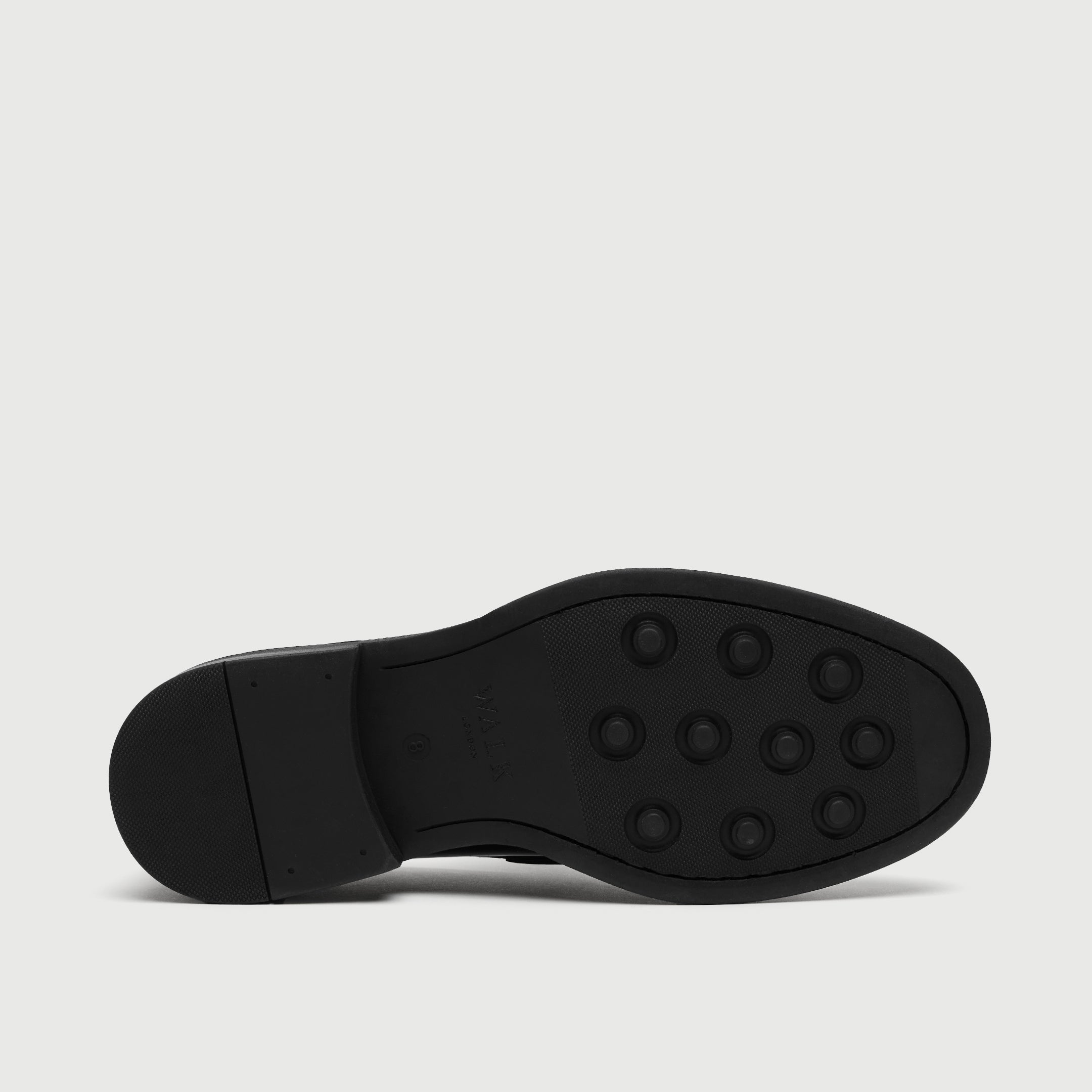 Black shoe sole on a light gray background - Walk London Parsons Saddle Loafer in Black Leather