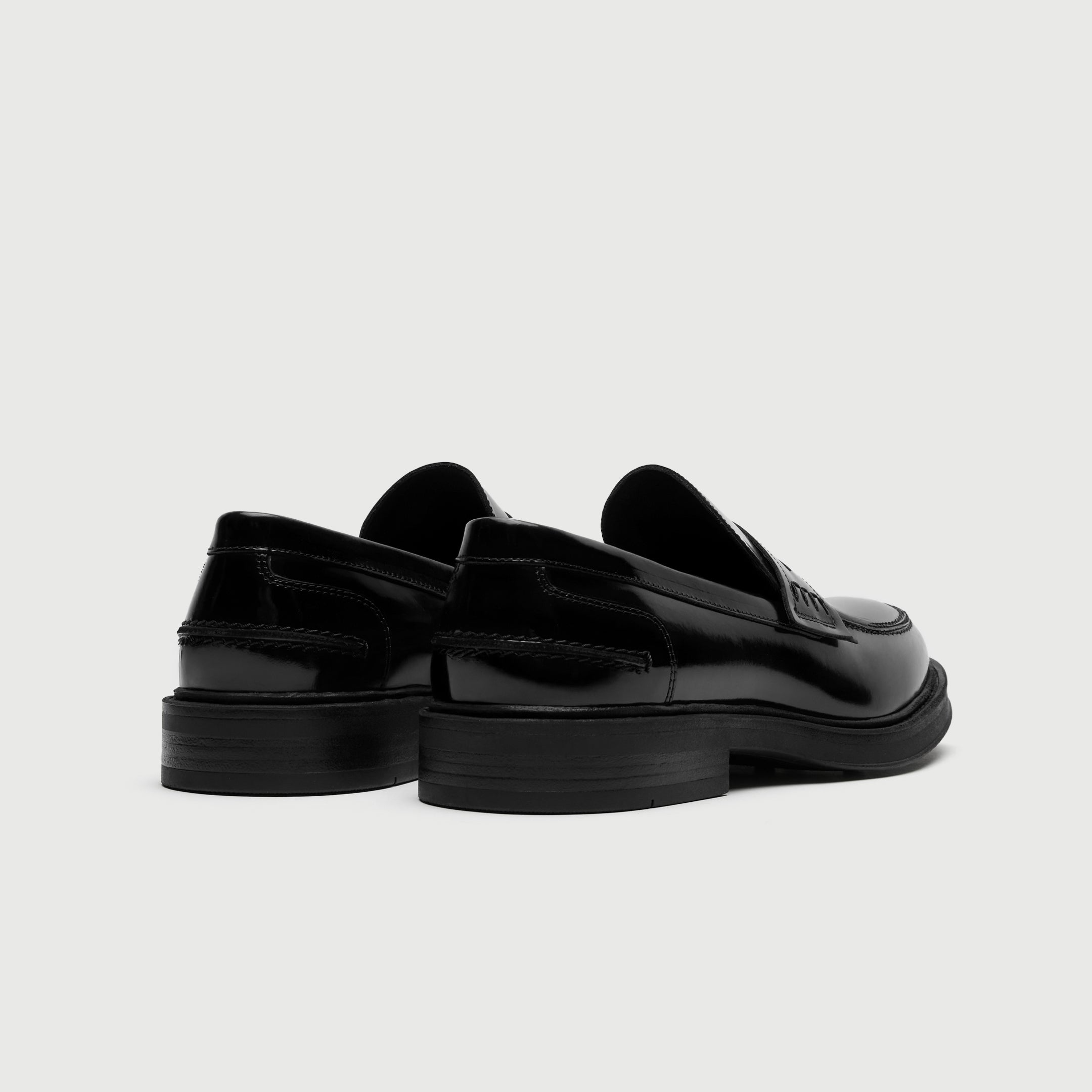 Black loafers on a light gray background - Walk London Parsons Saddle Loafer in Black Leather